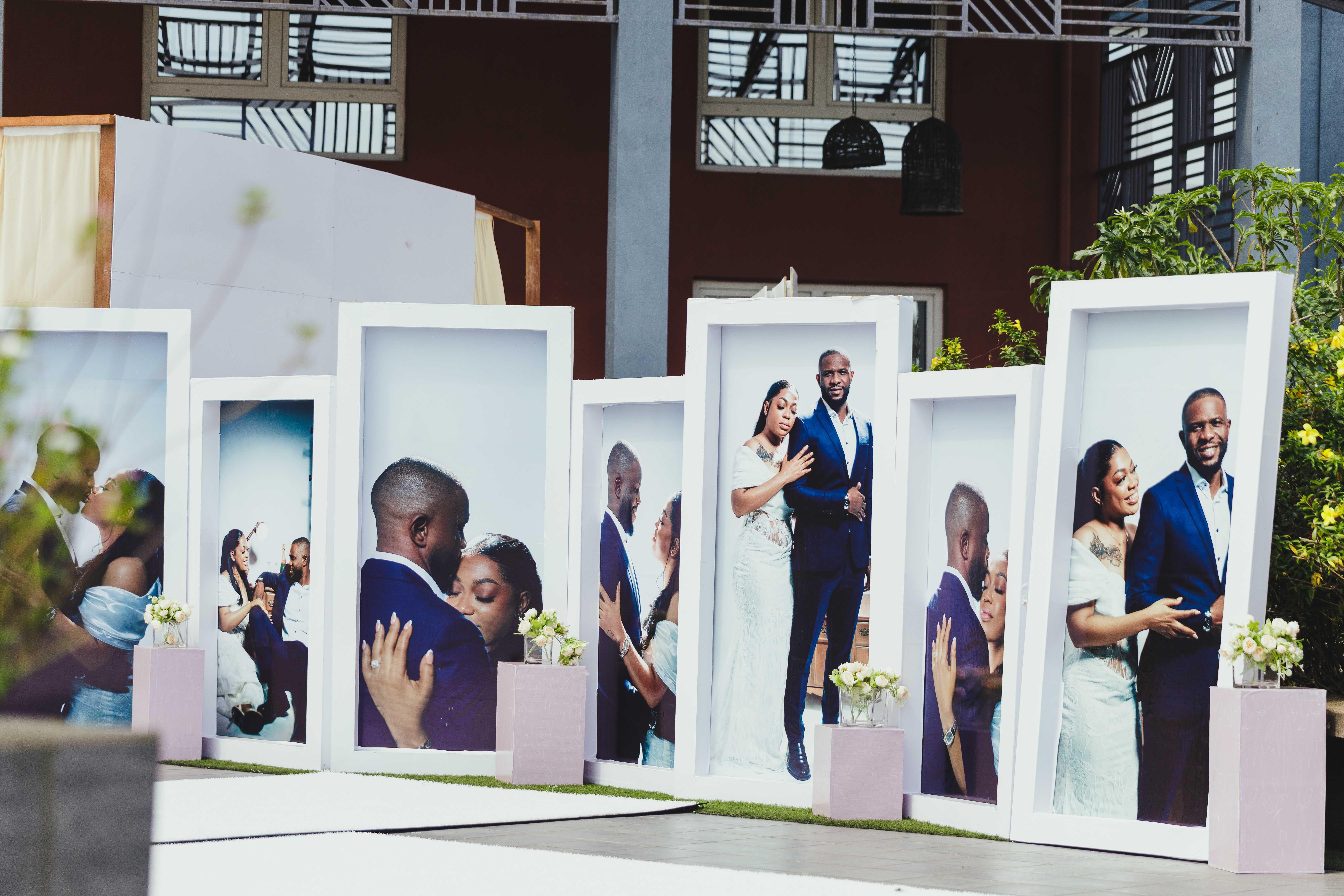 Large portrait displays at an African outdoor wedding showcasing a couple's special moments.
