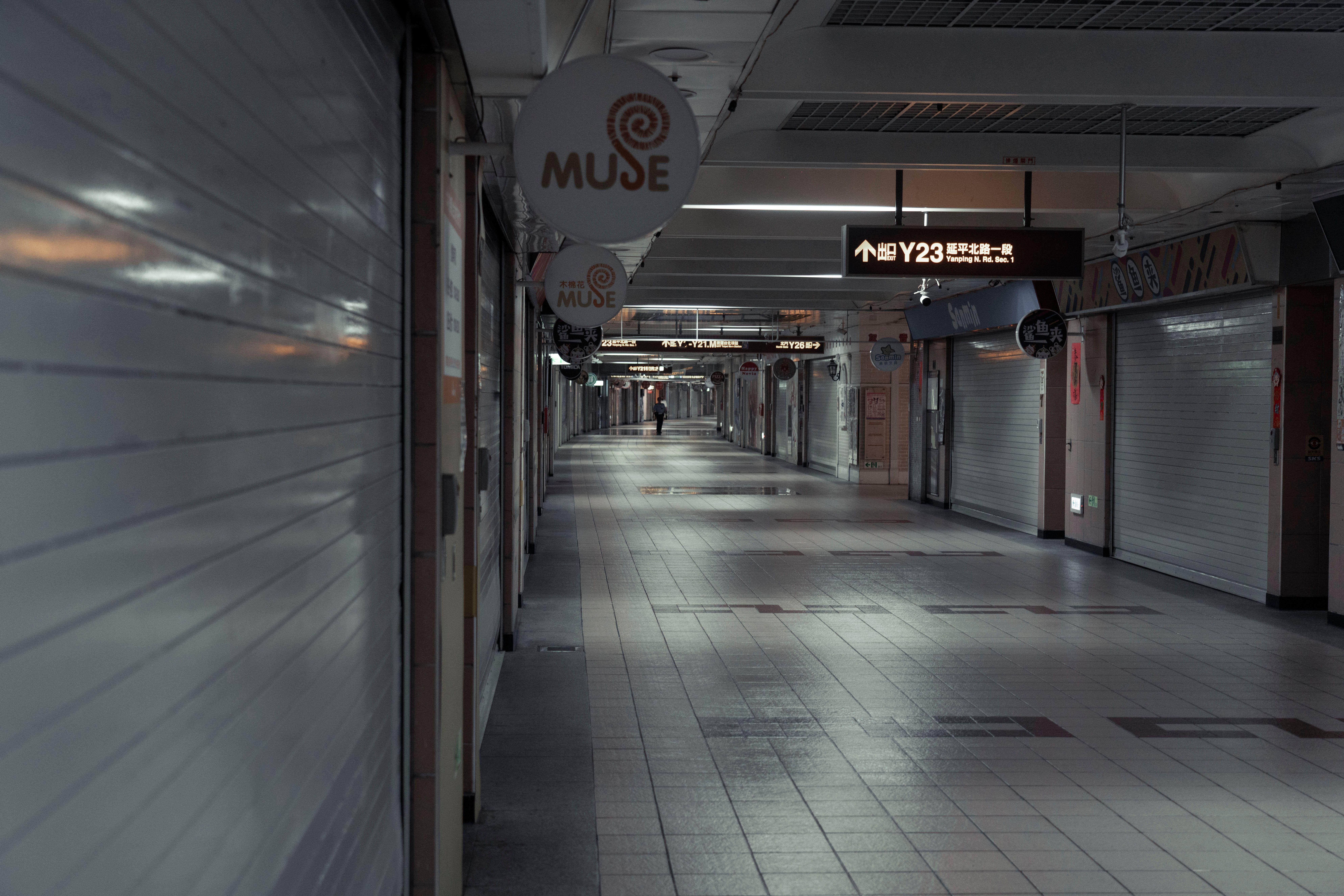 A deserted underground corridor in Taipei City showcasing urban architecture and signage.