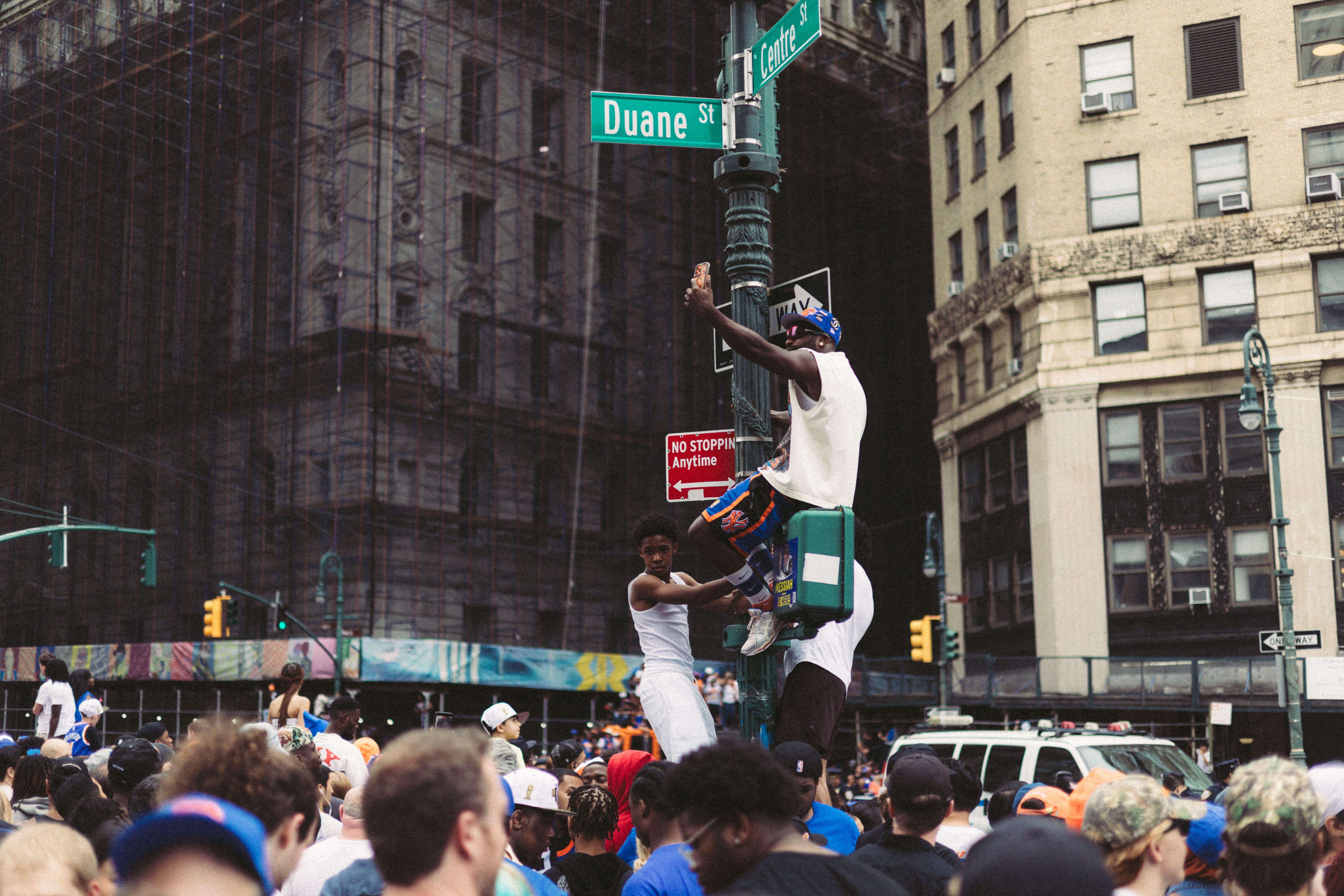 Energetic crowd gathered at Duane Street in New York City, showcasing urban celebration and street life.