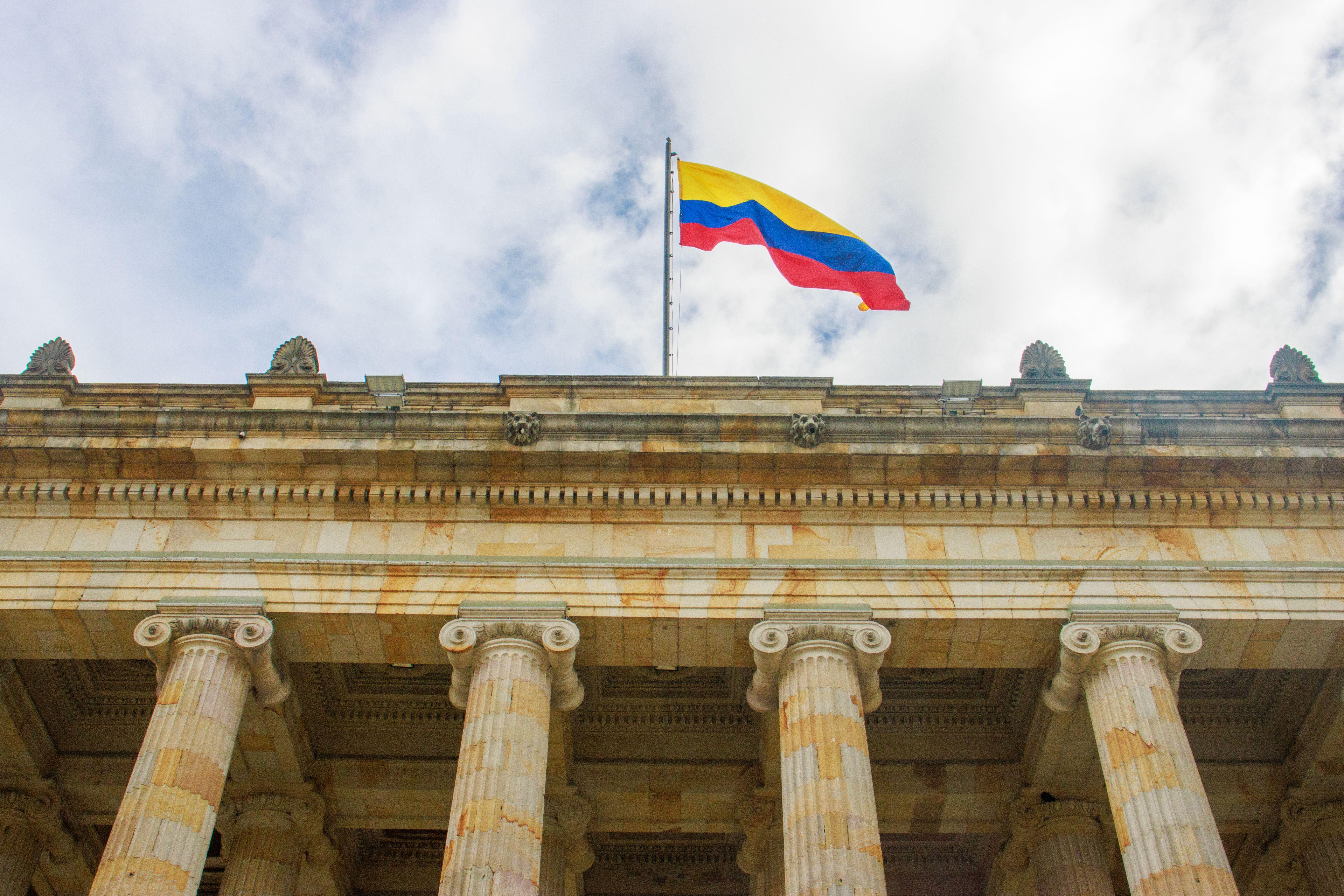 View of the Colombian Capitol Building in Bogotá with the Colombian flag displayed prominently.