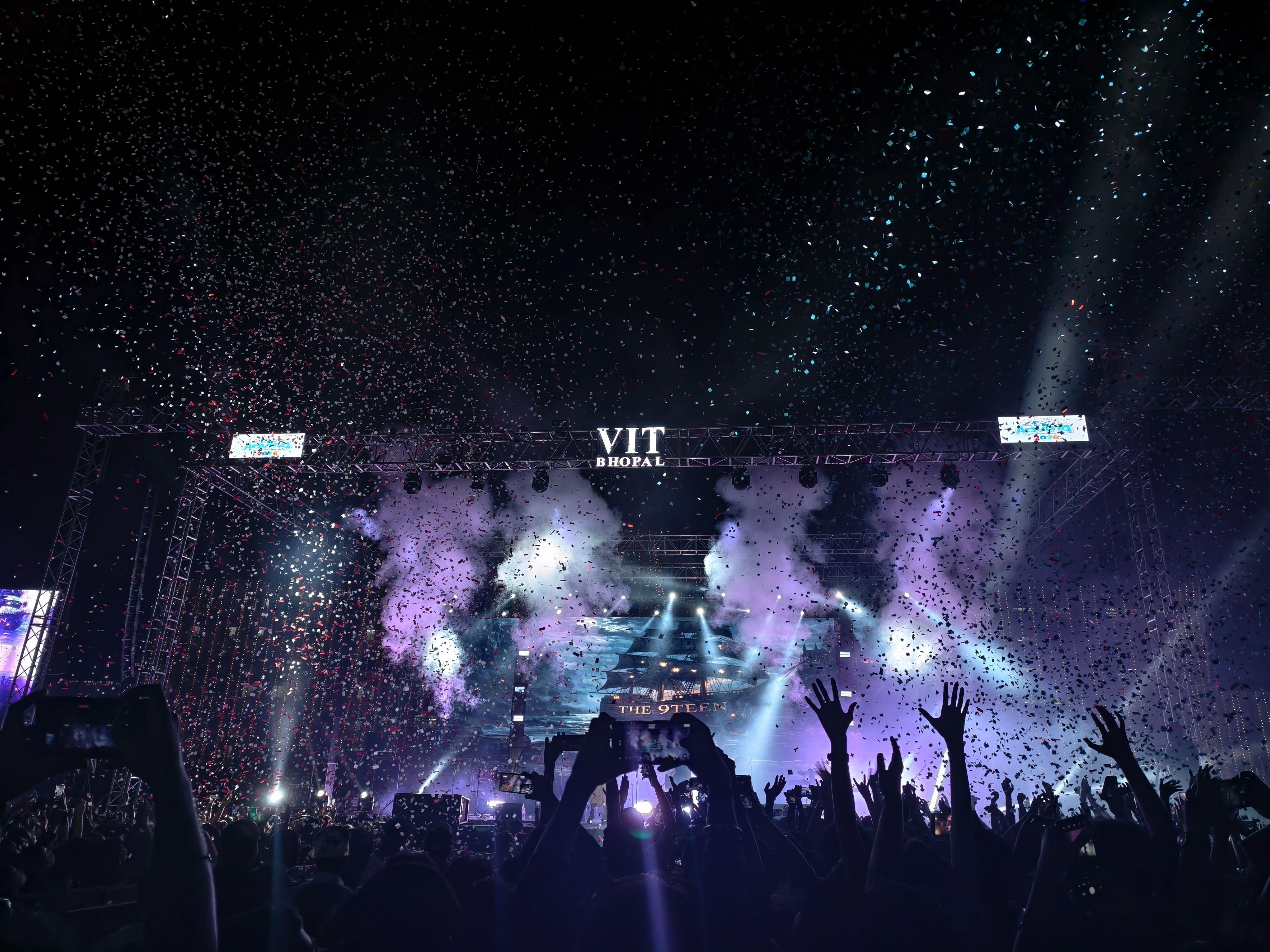 Dynamic night concert at VIT Bhopal with confetti and vibrant stage lighting.