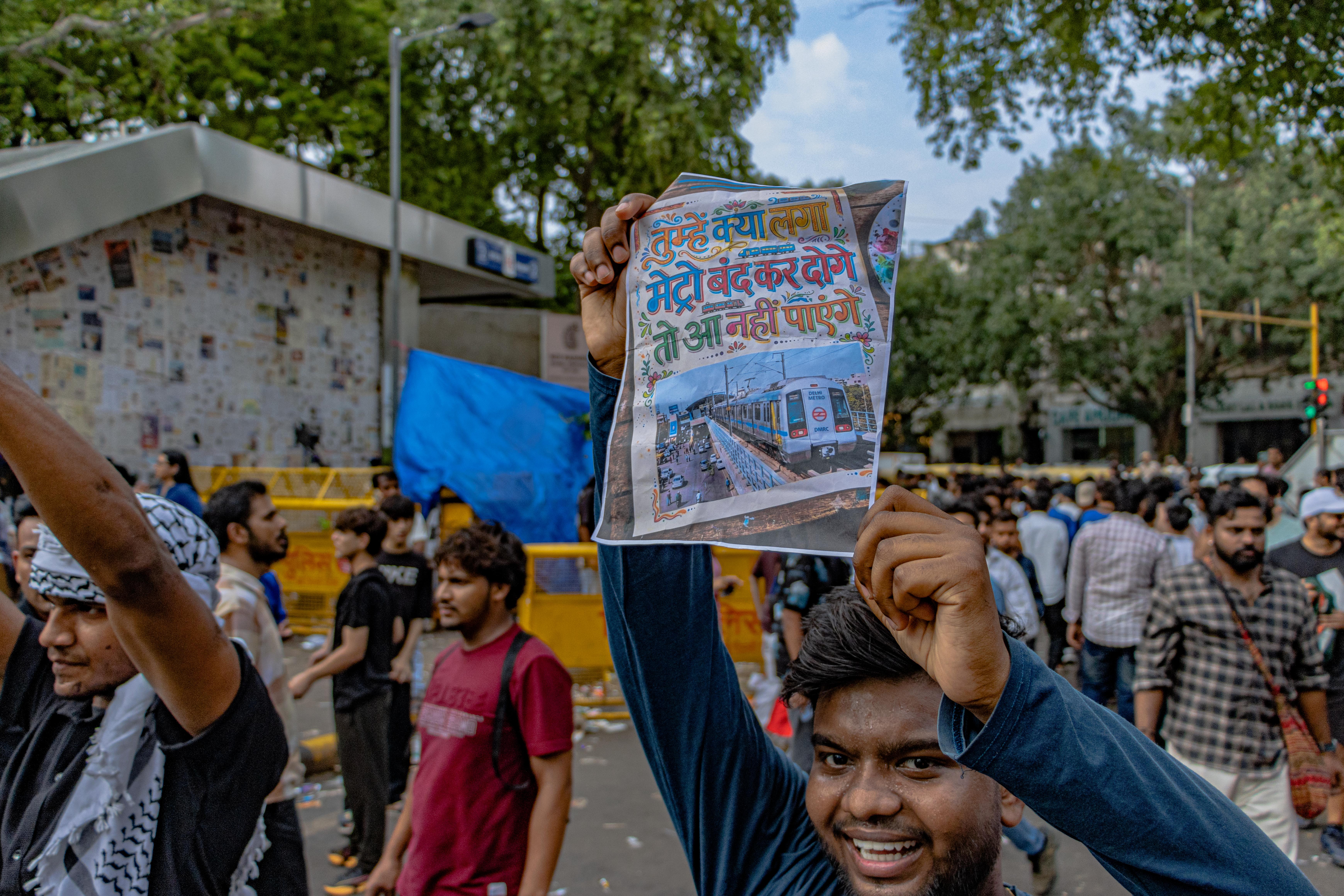 Protesters congregate at Jantar Mantar, New Delhi, holding up signs for peaceful demonstration.