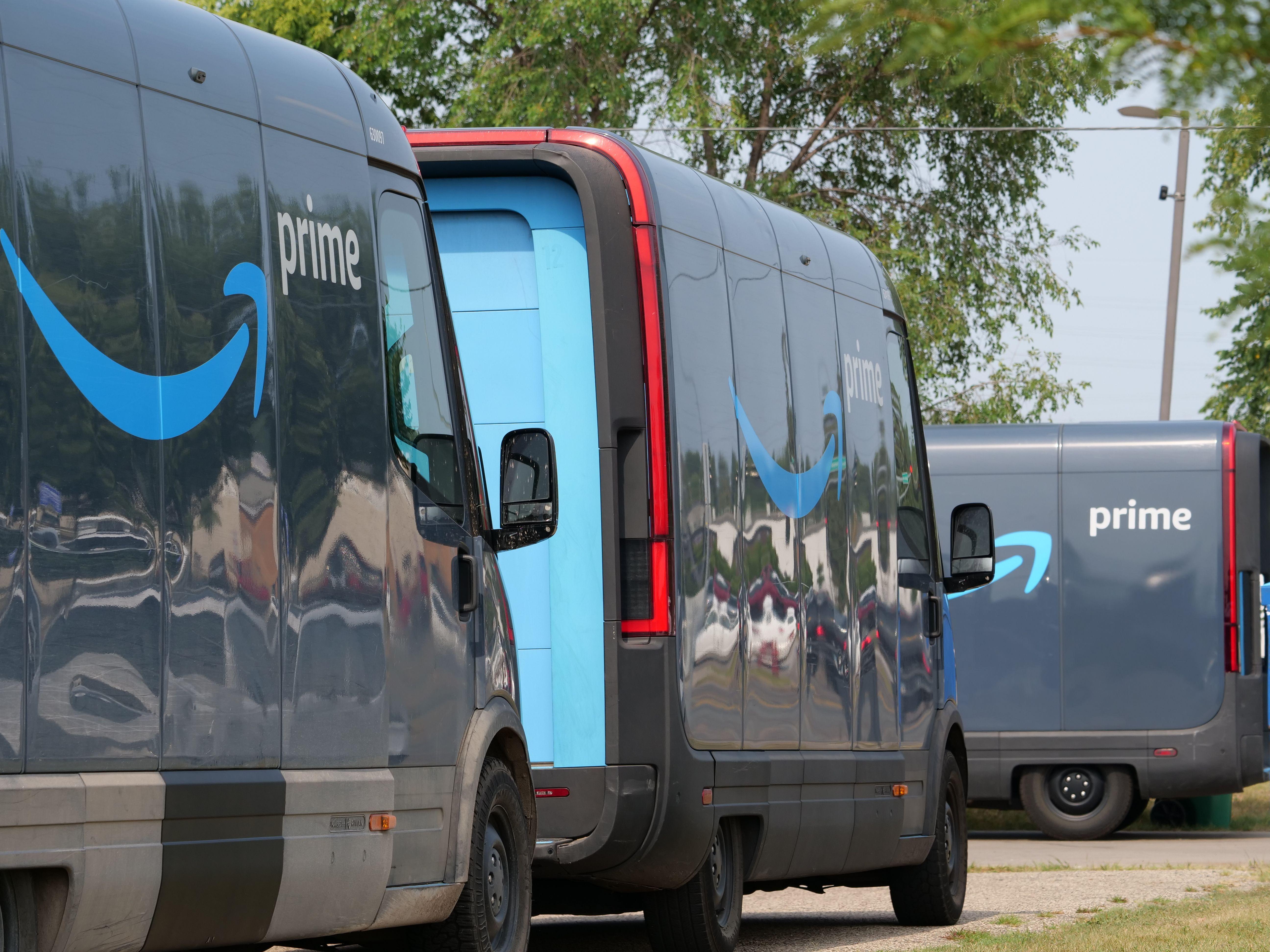 Amazon Prime delivery vans lined up for logistics operations in an urban setting.