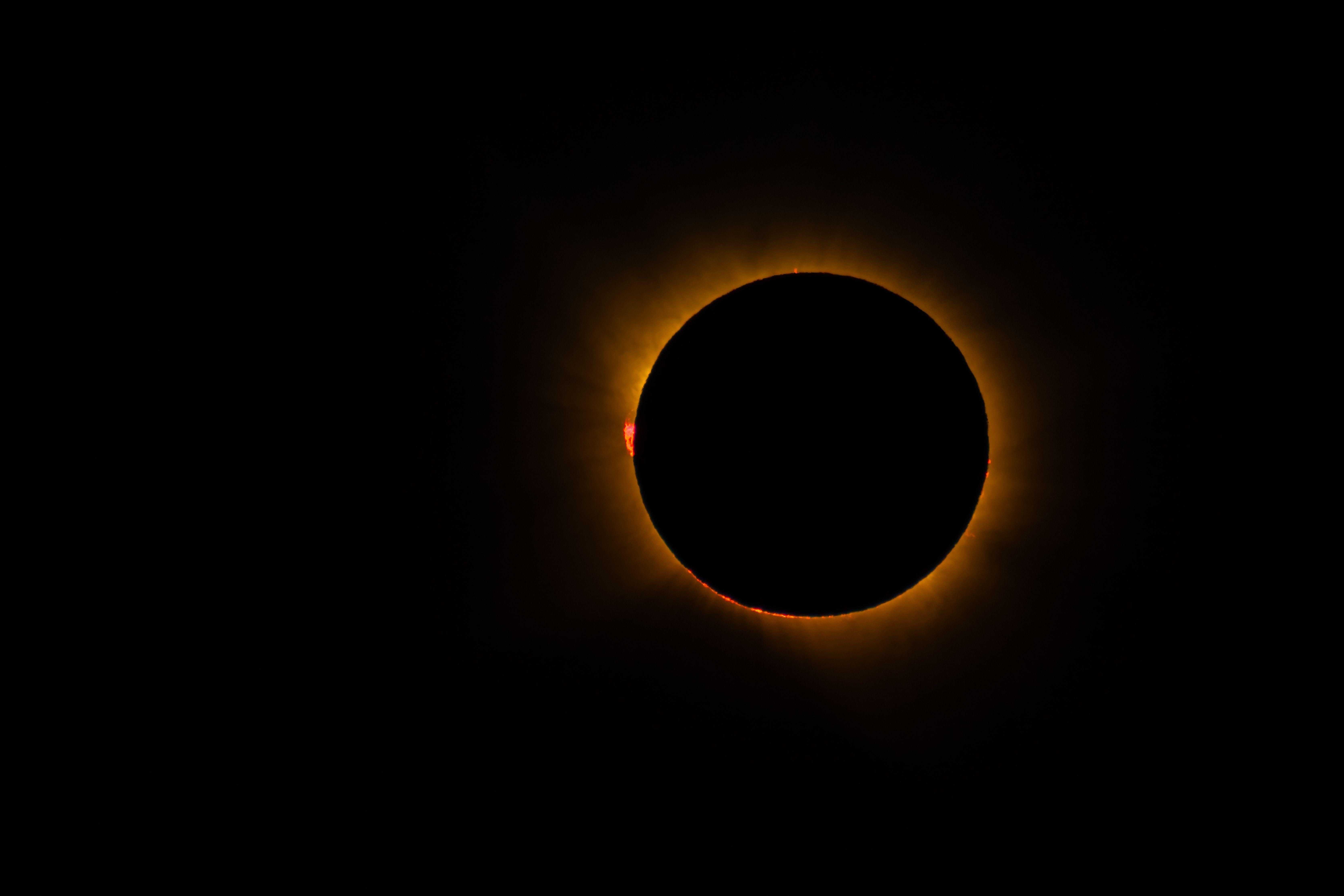 Capture of a total solar eclipse, showcasing the solar corona and lunar silhouette.