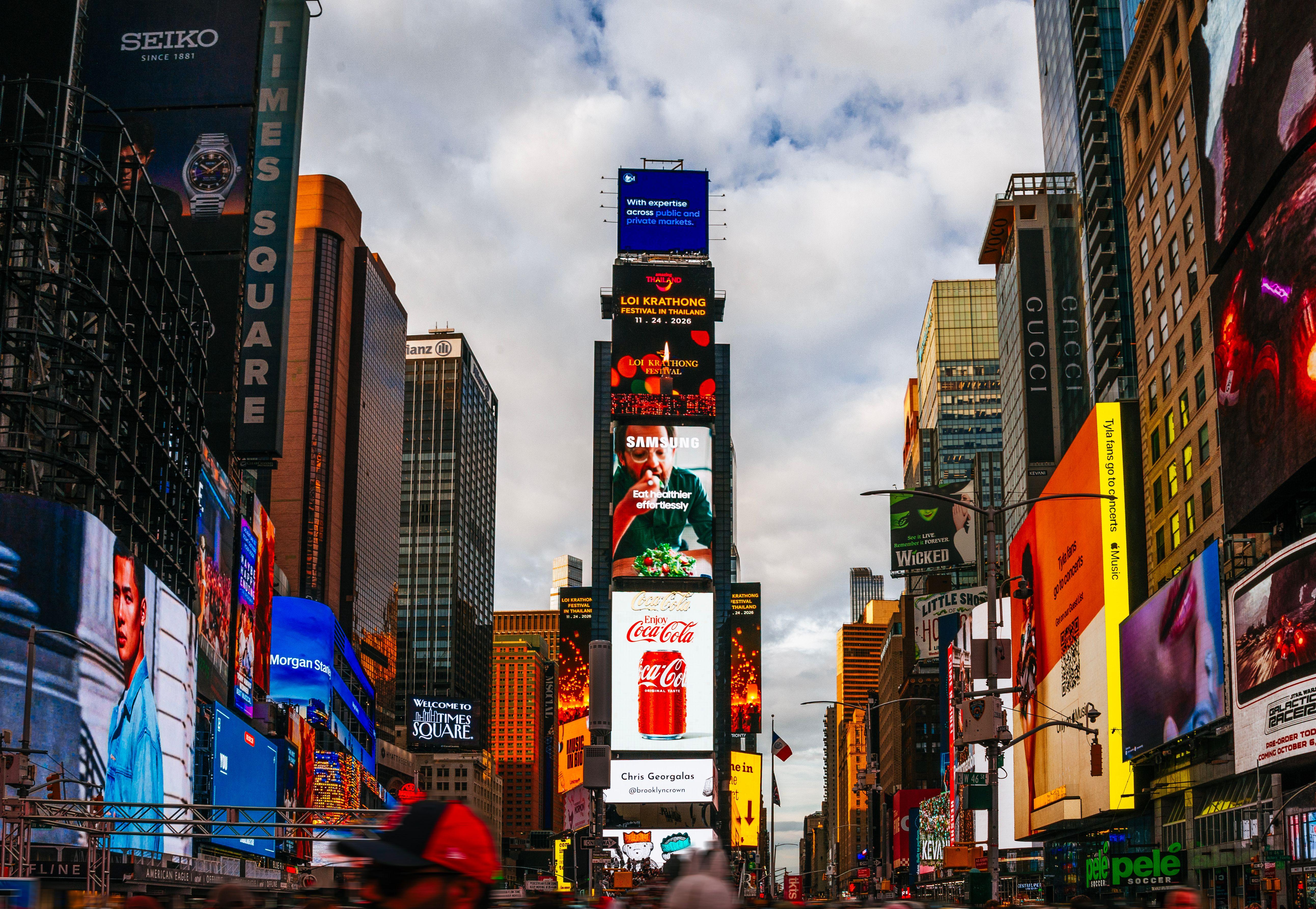 Vibrant Times Square in New York City with bustling activity and illuminated billboards.