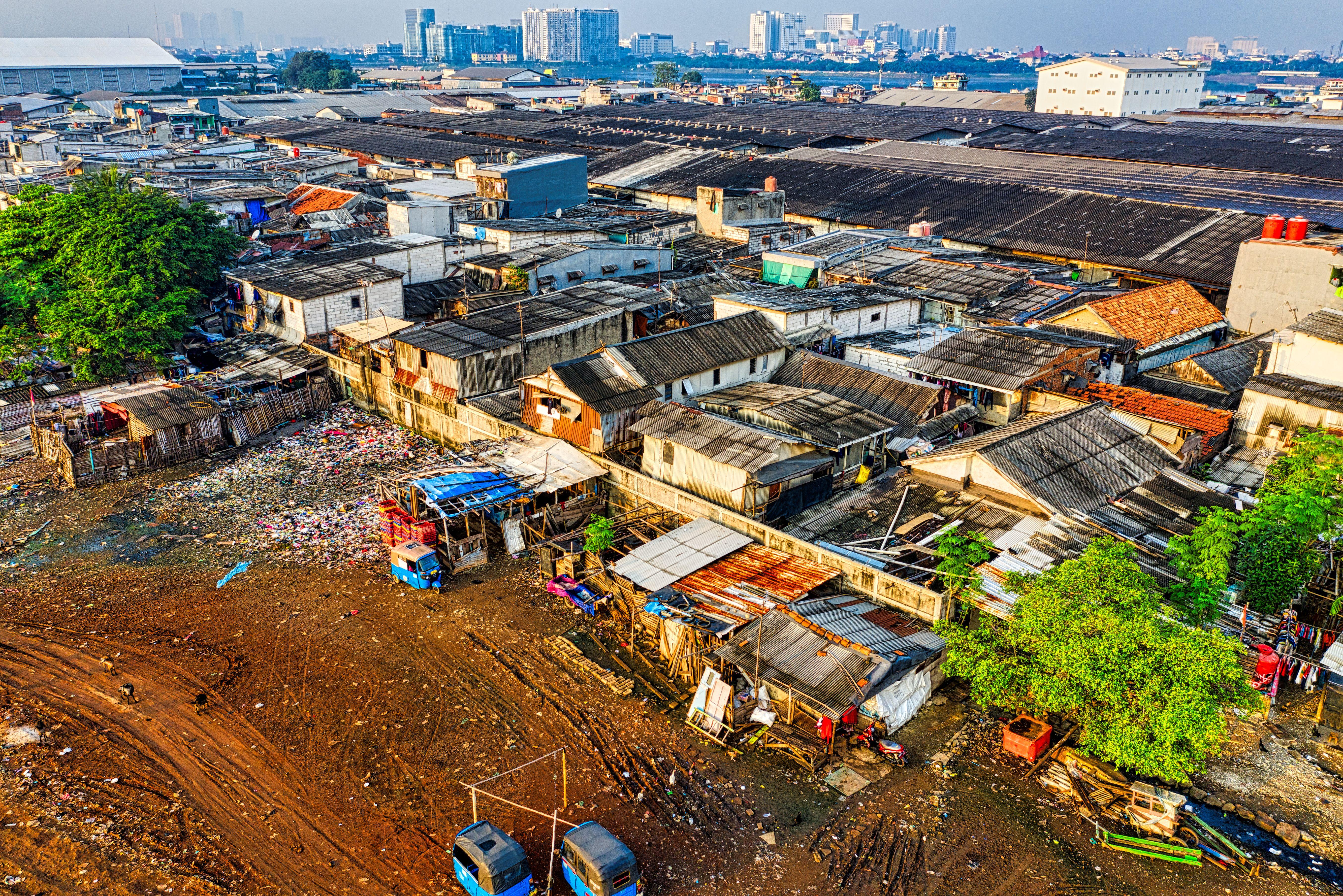 Aerial shot depicting urban slums in Jakarta with visible pollution and crowded housing.