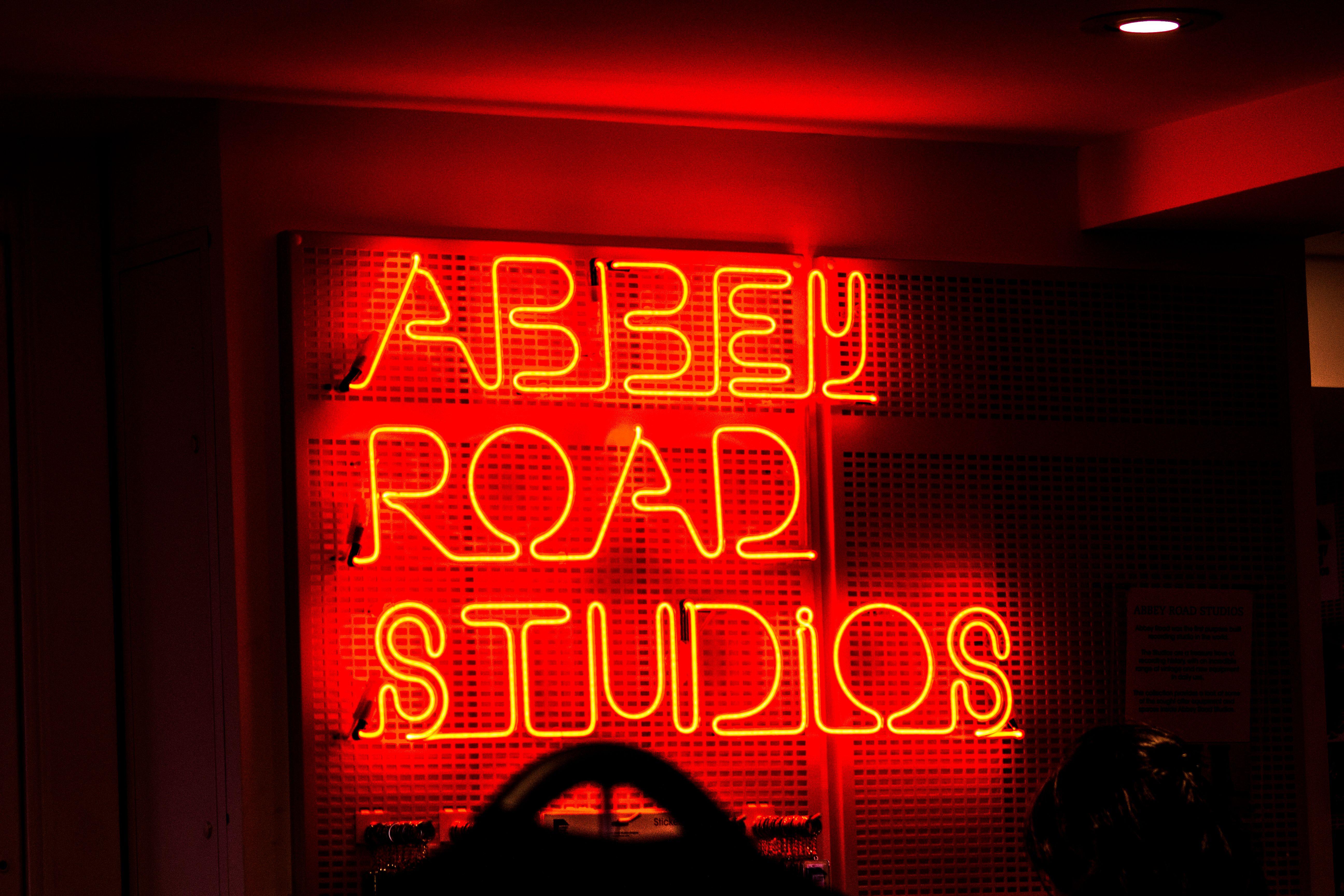 Vibrant neon sign of Abbey Road Studios, an iconic music recording location.
