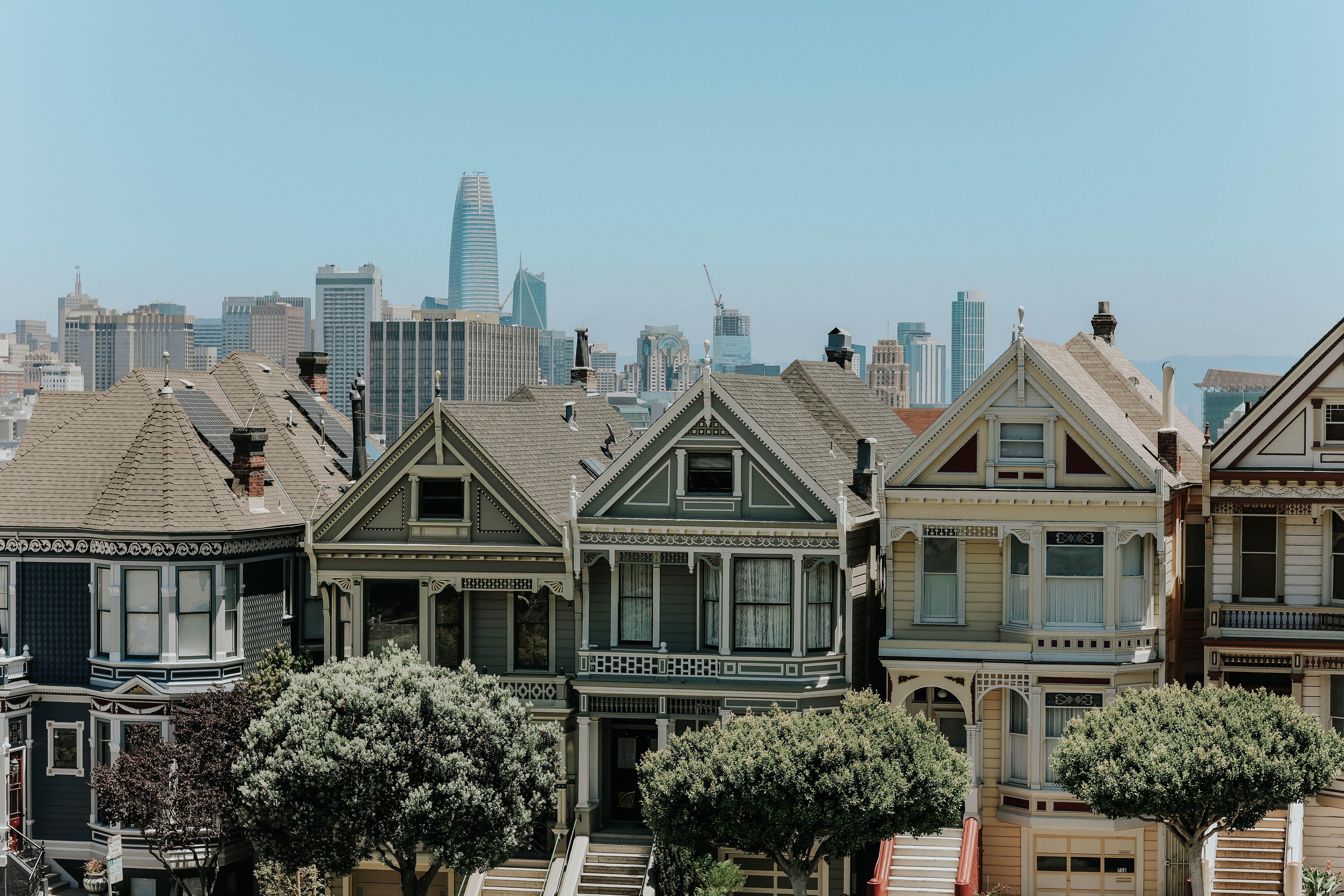 Captivating view of San Francisco's famous Victorian houses with city skyline in the background.