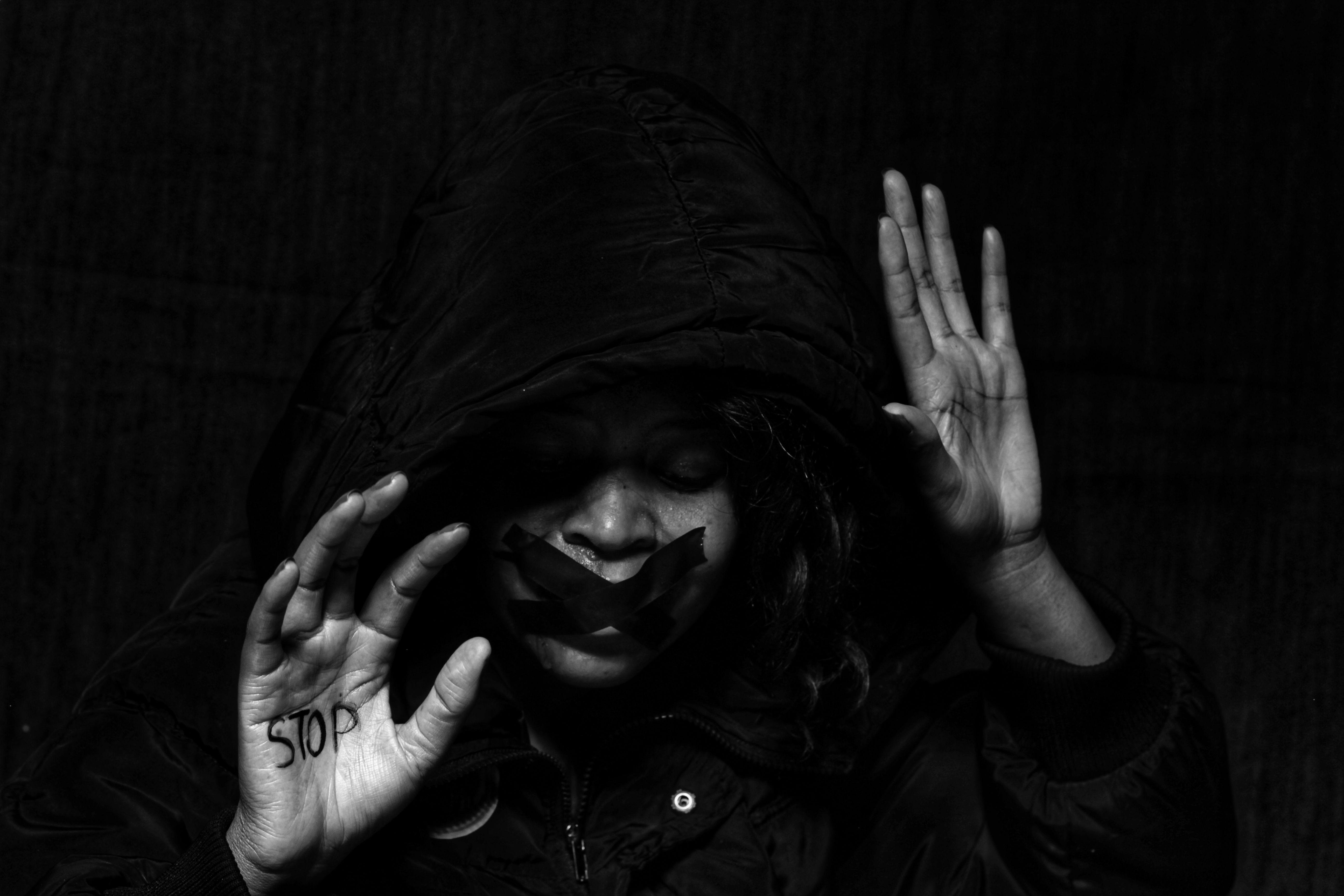 Powerful black and white image highlighting women’s rights and abuse prevention.