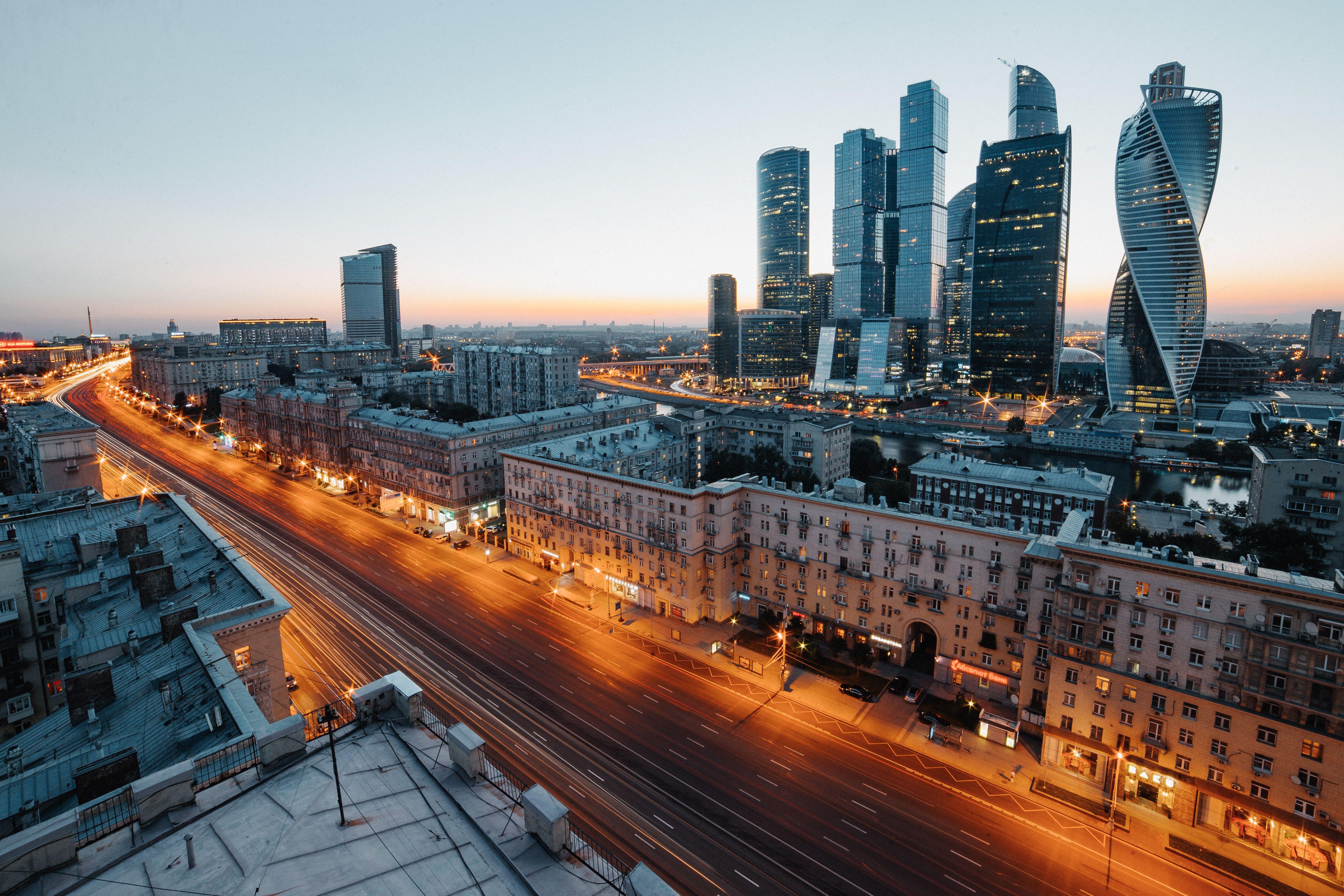 Aerial view of Moscow's skyscrapers and urban skyline during twilight, showcasing modern architecture.