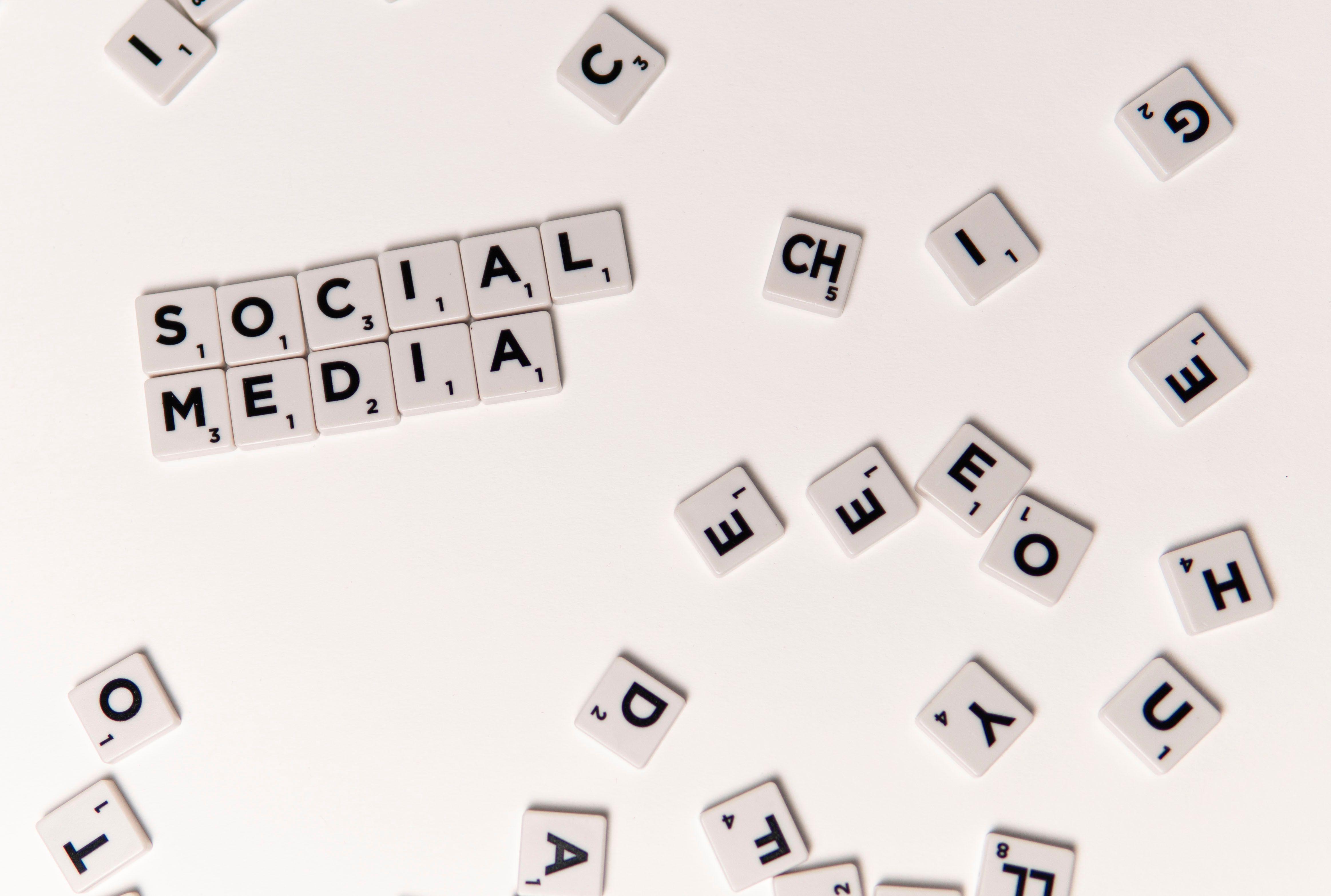 Scrabble tiles spelling 'Social Media' on a white background, symbolizing digital communication.