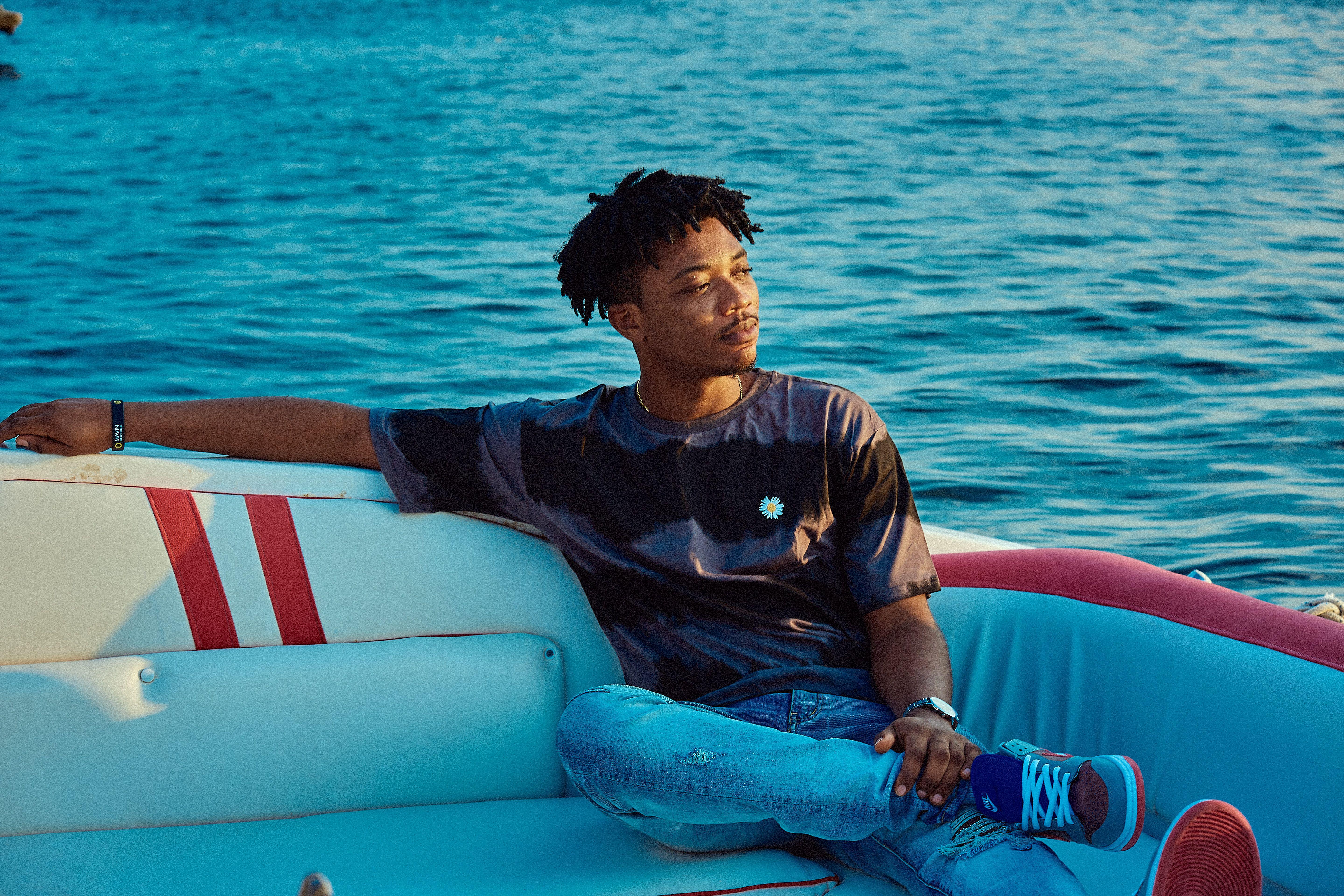 A young man enjoying a serene moment on a boat in Lagos, Nigeria.