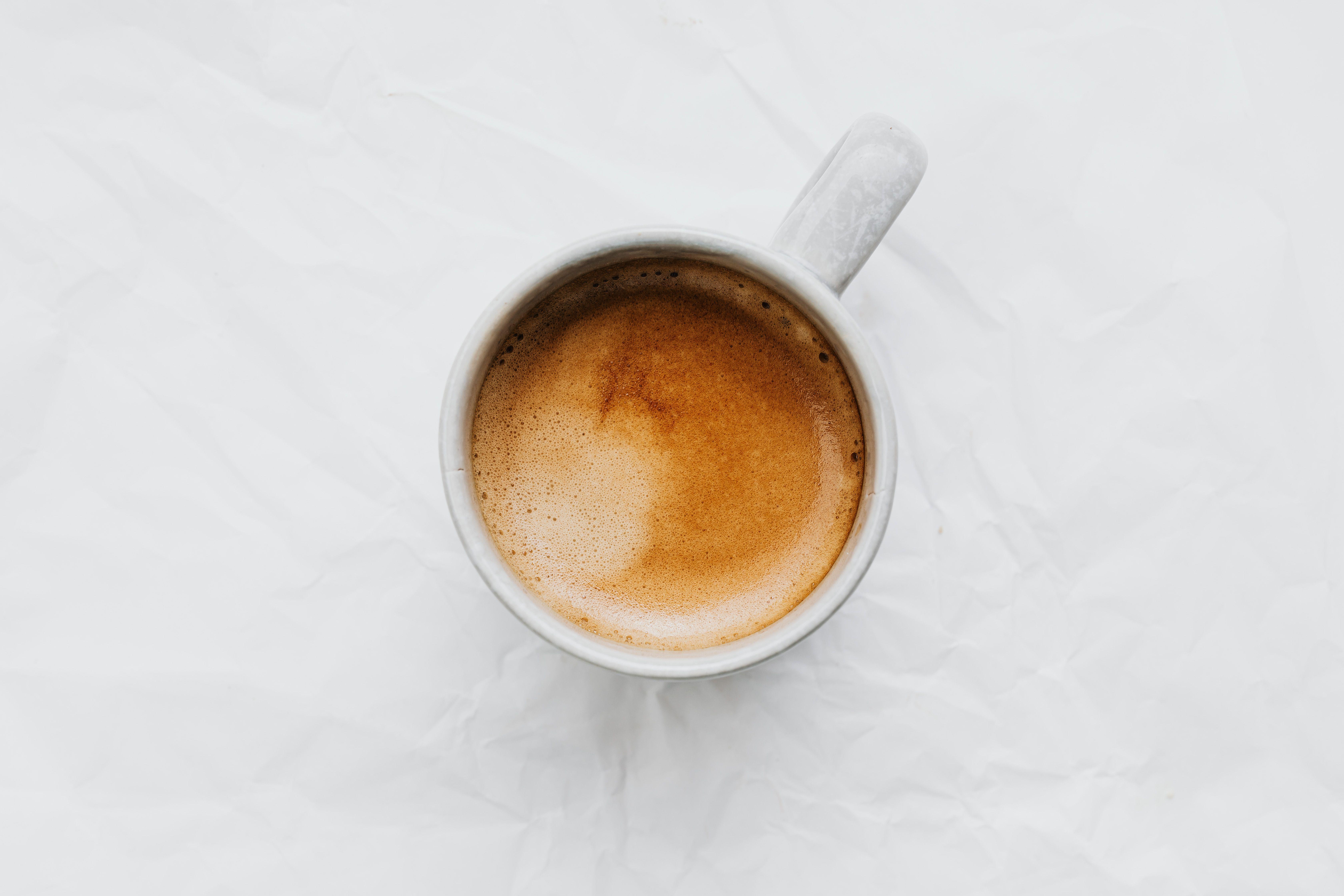 Aerial view of a coffee cup on a white background. Ideal for food and beverage themes.