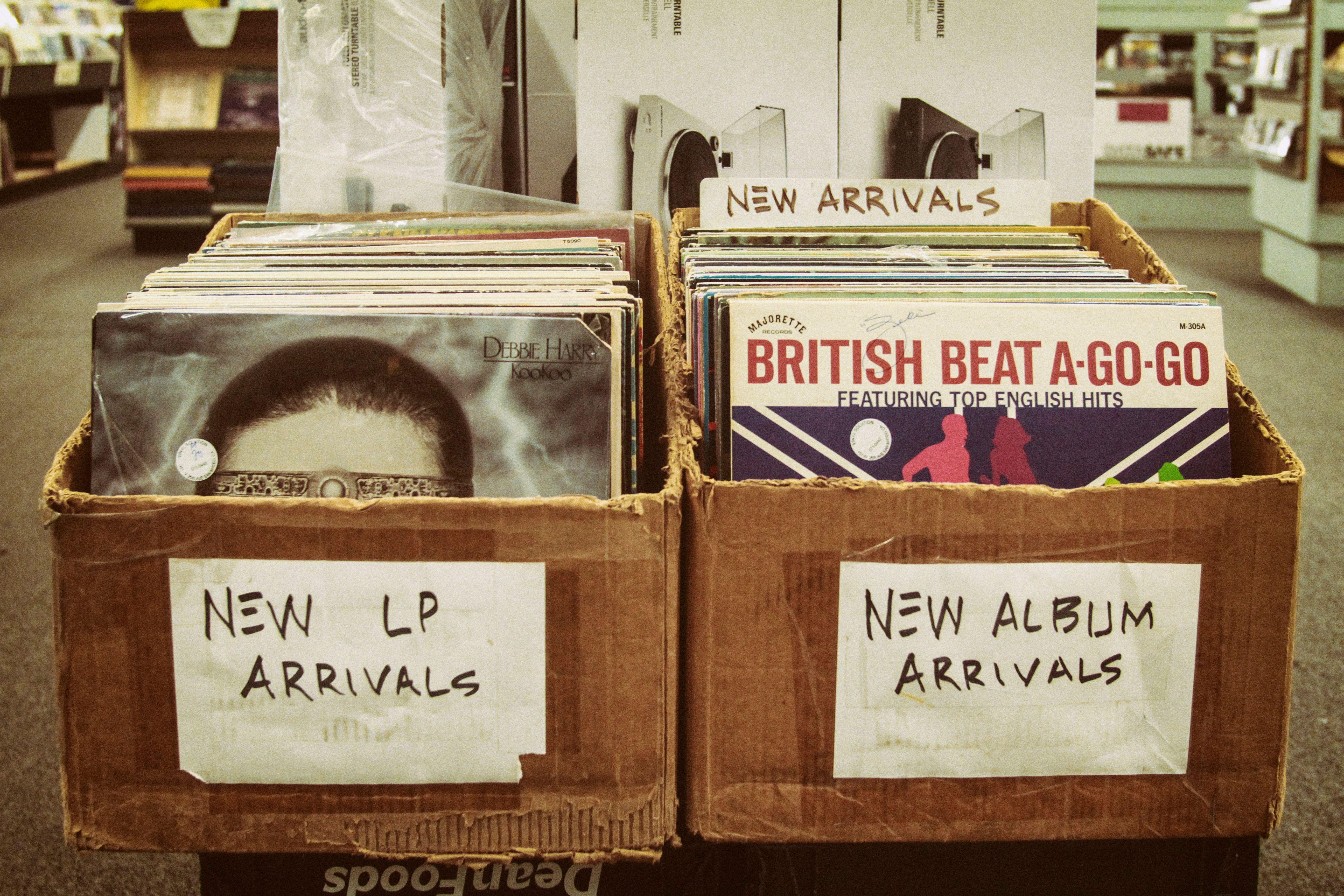 Explore a vintage record store with boxes of new LP and album arrivals.