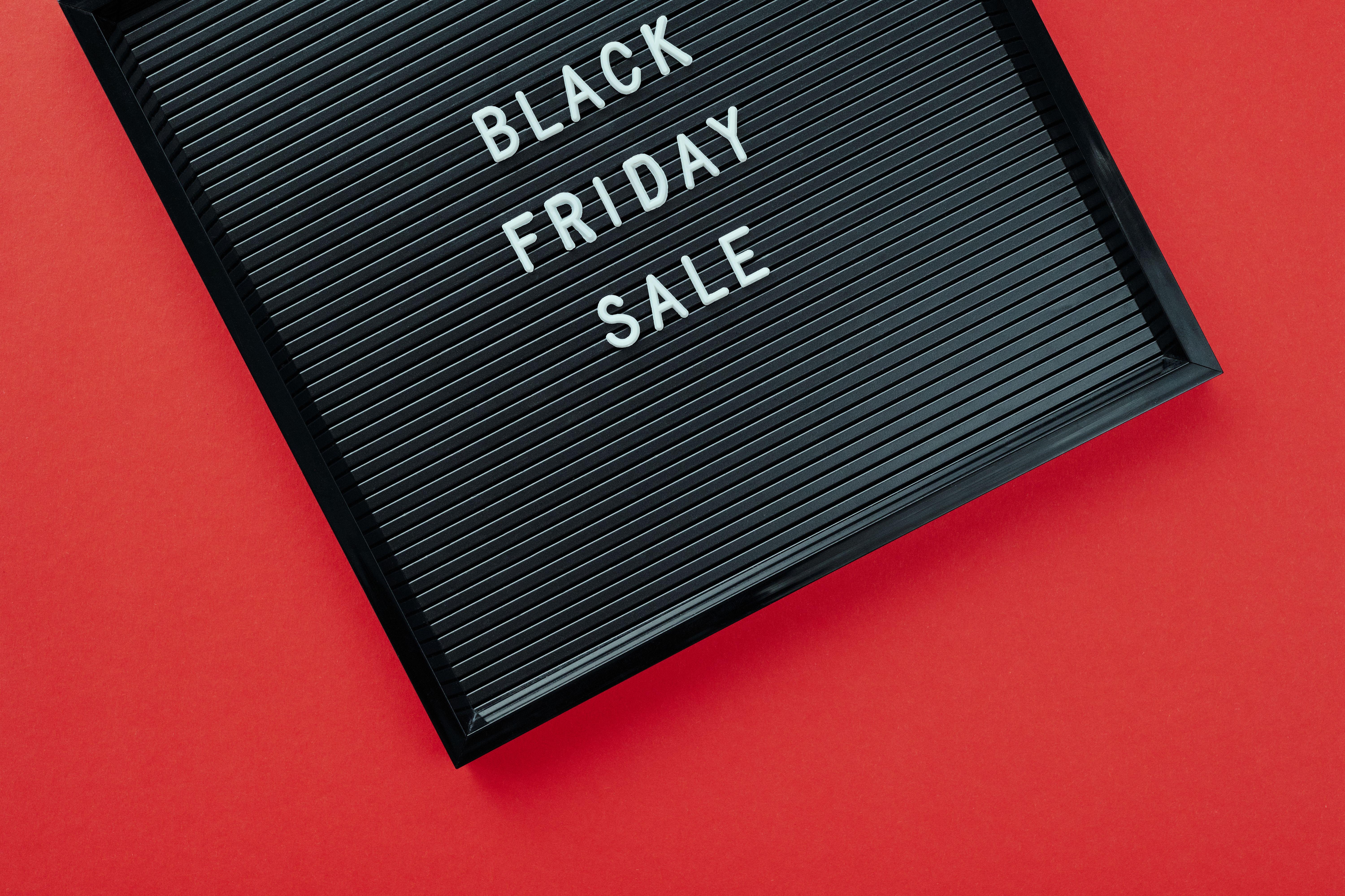 Black Friday sale sign on bold red surface, perfect for promotions.