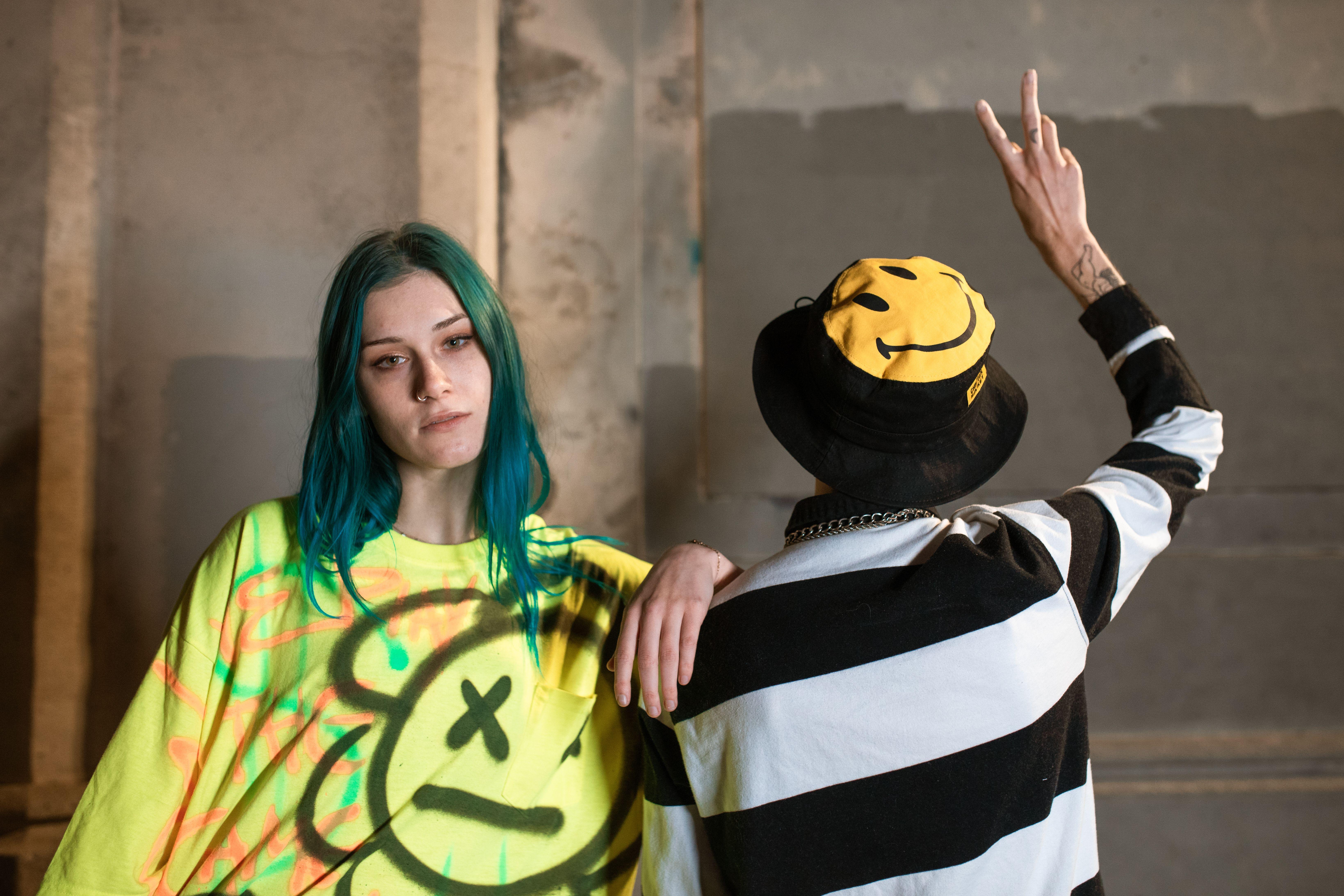 Trendy urban fashion with vibrant graffiti background featuring unique street style.