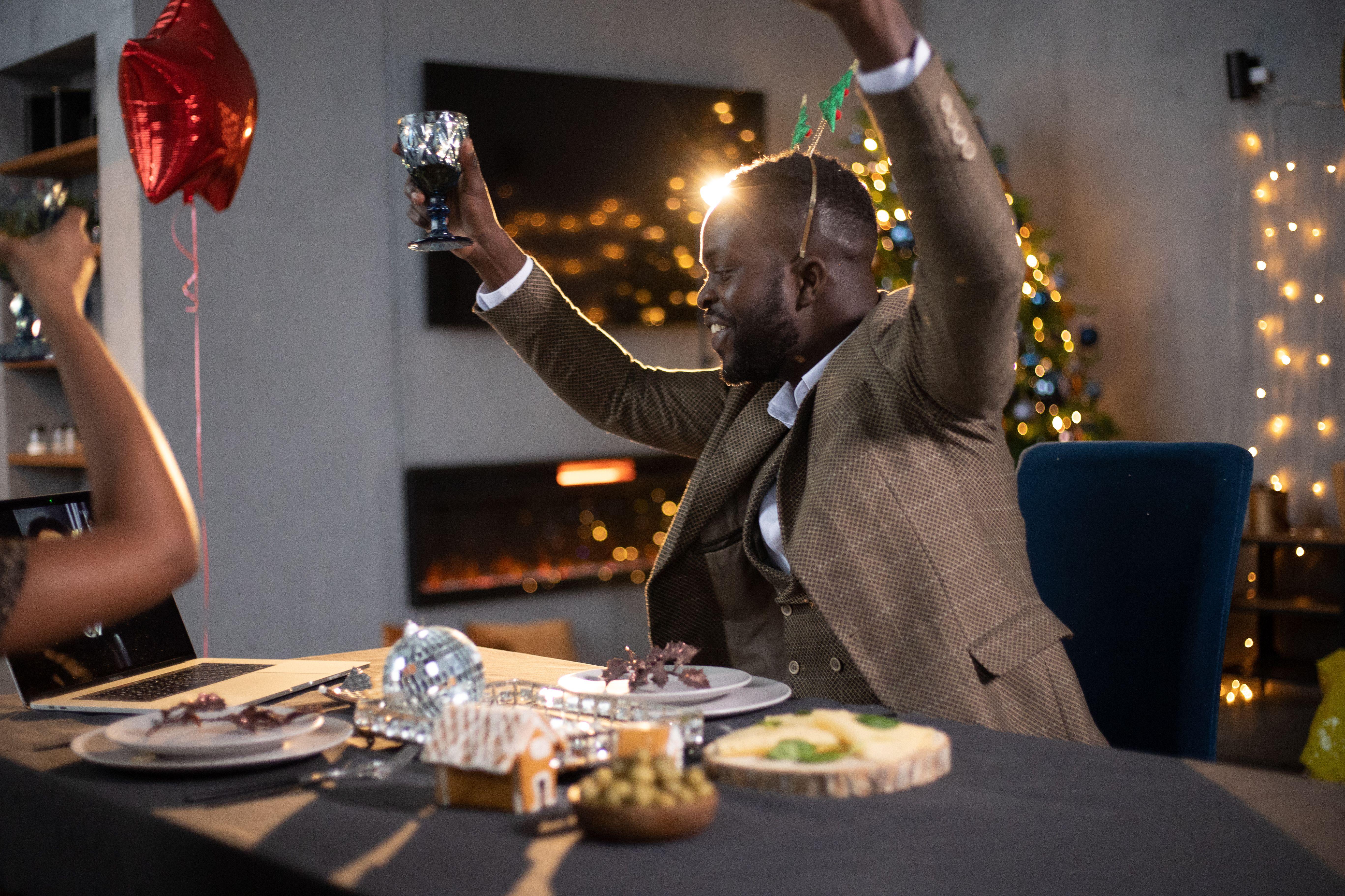 Joyful Christmas party with friends celebrating indoors. Warm, festive vibes.