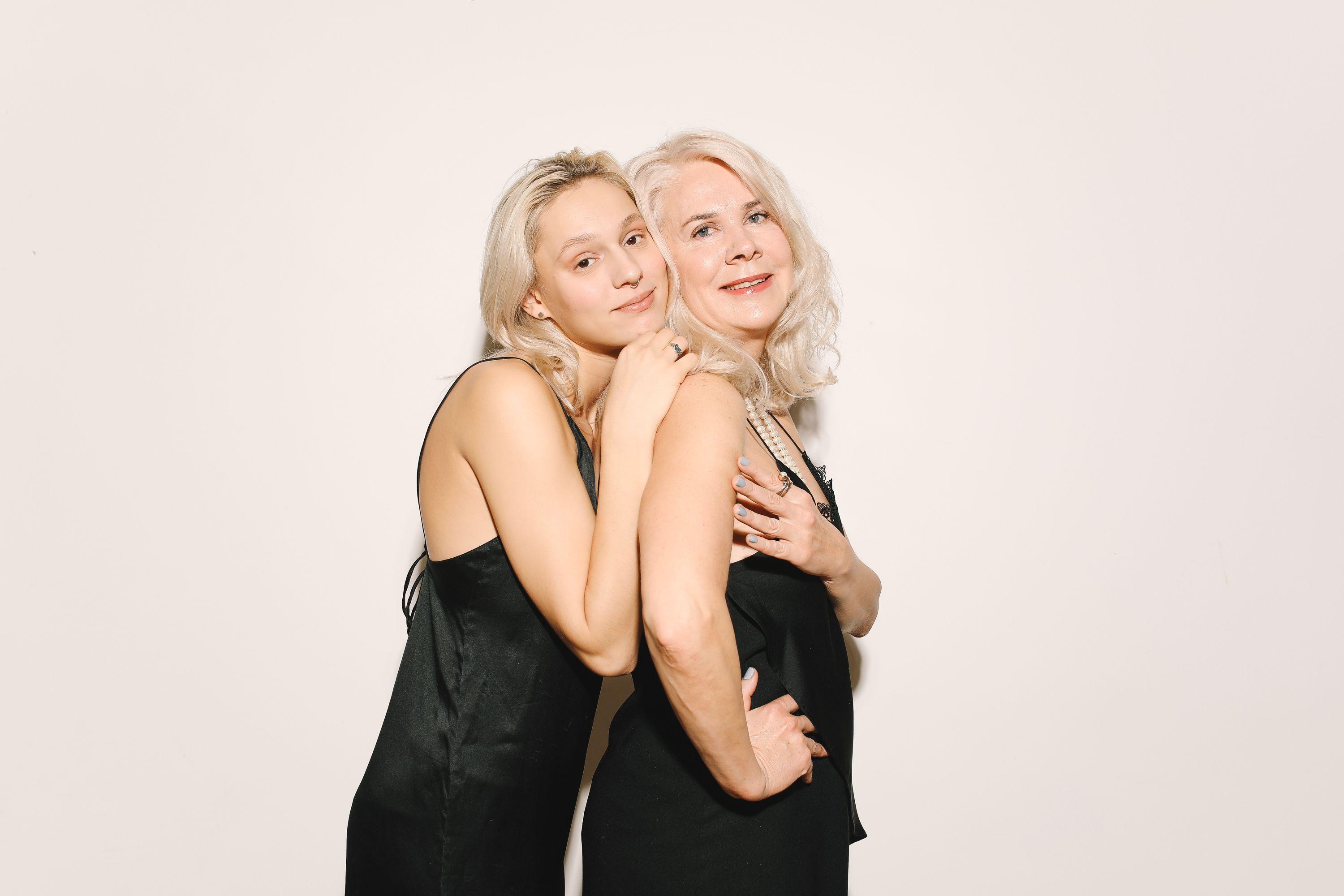 Portrait of a mother and daughter in stylish black dresses, exuding warmth and affection.