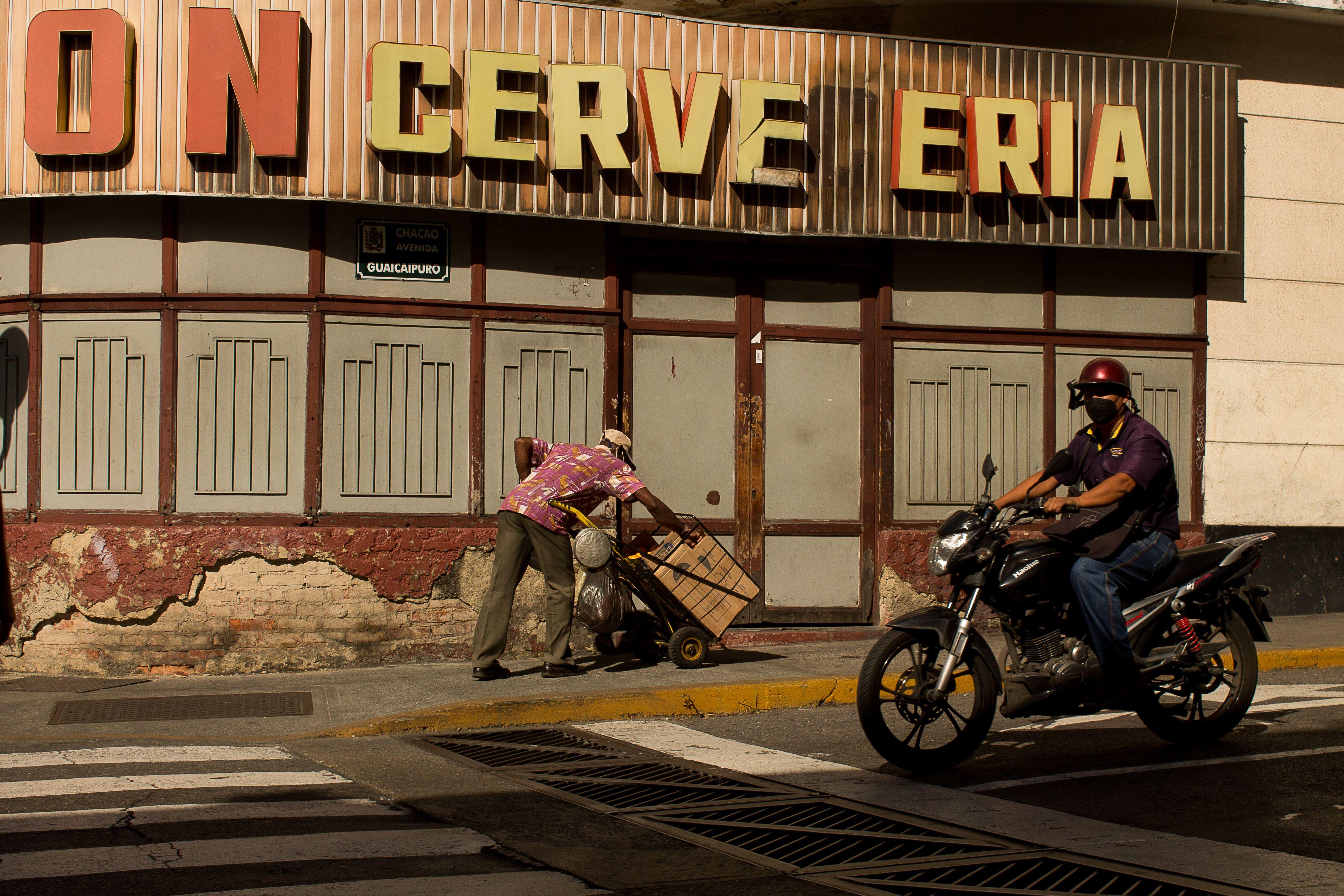 A moment in Caracas showcasing urban life with a motorcyclist and street vendor.