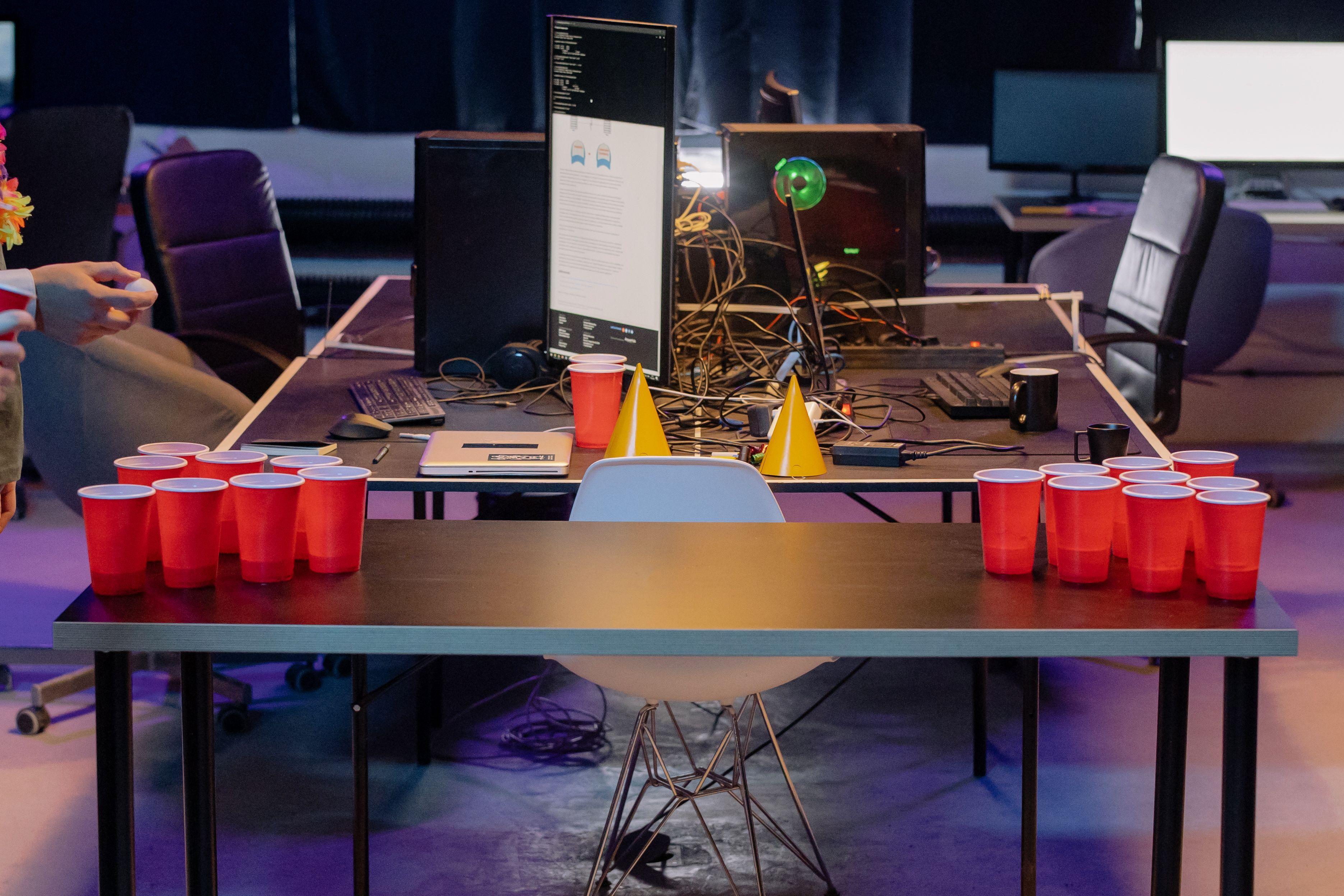 Casual office party setup with beer pong and red cups for a fun atmosphere.