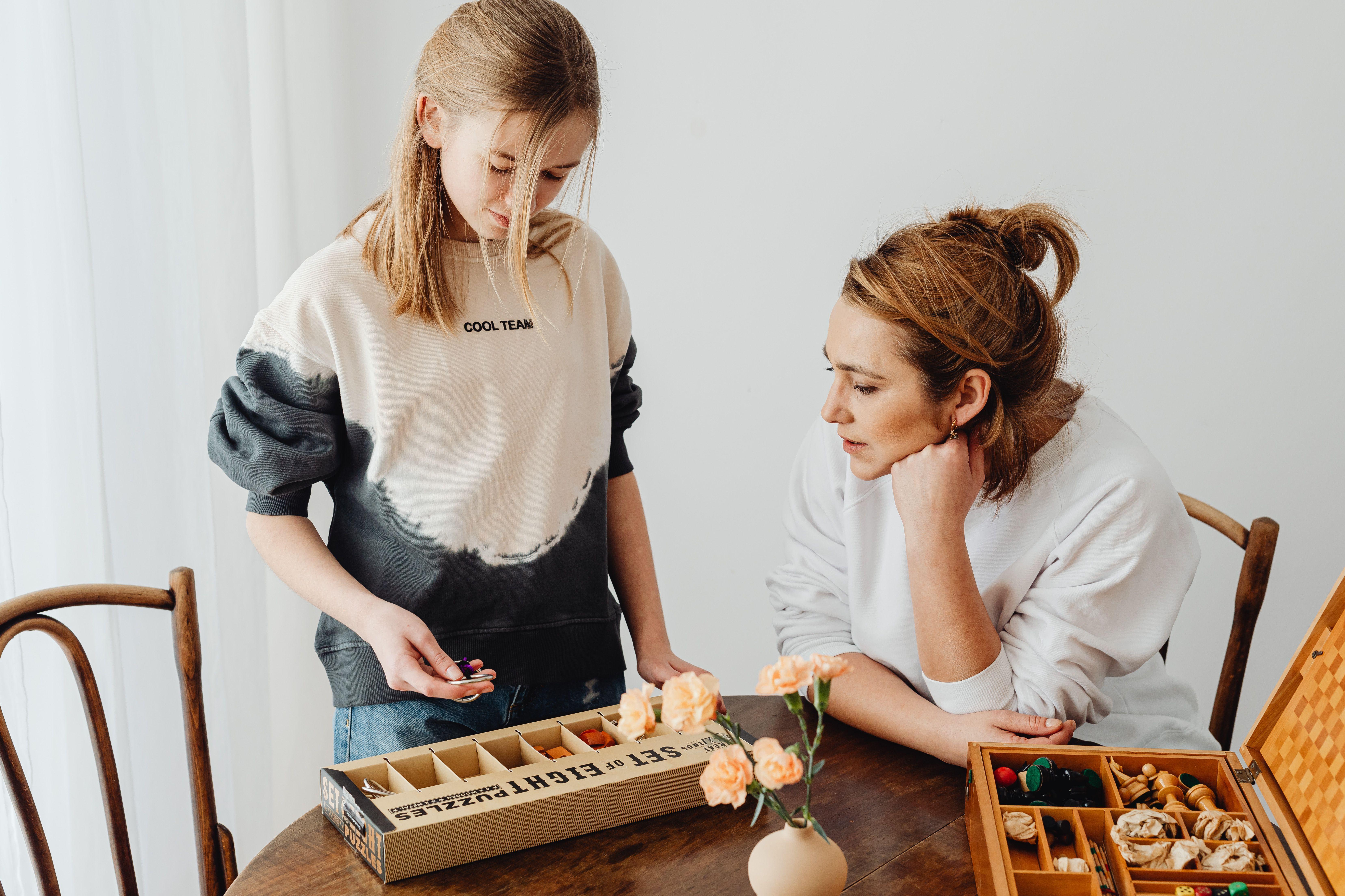 A mother and daughter engaged in puzzle-solving, enhancing creativity and bonding indoors.