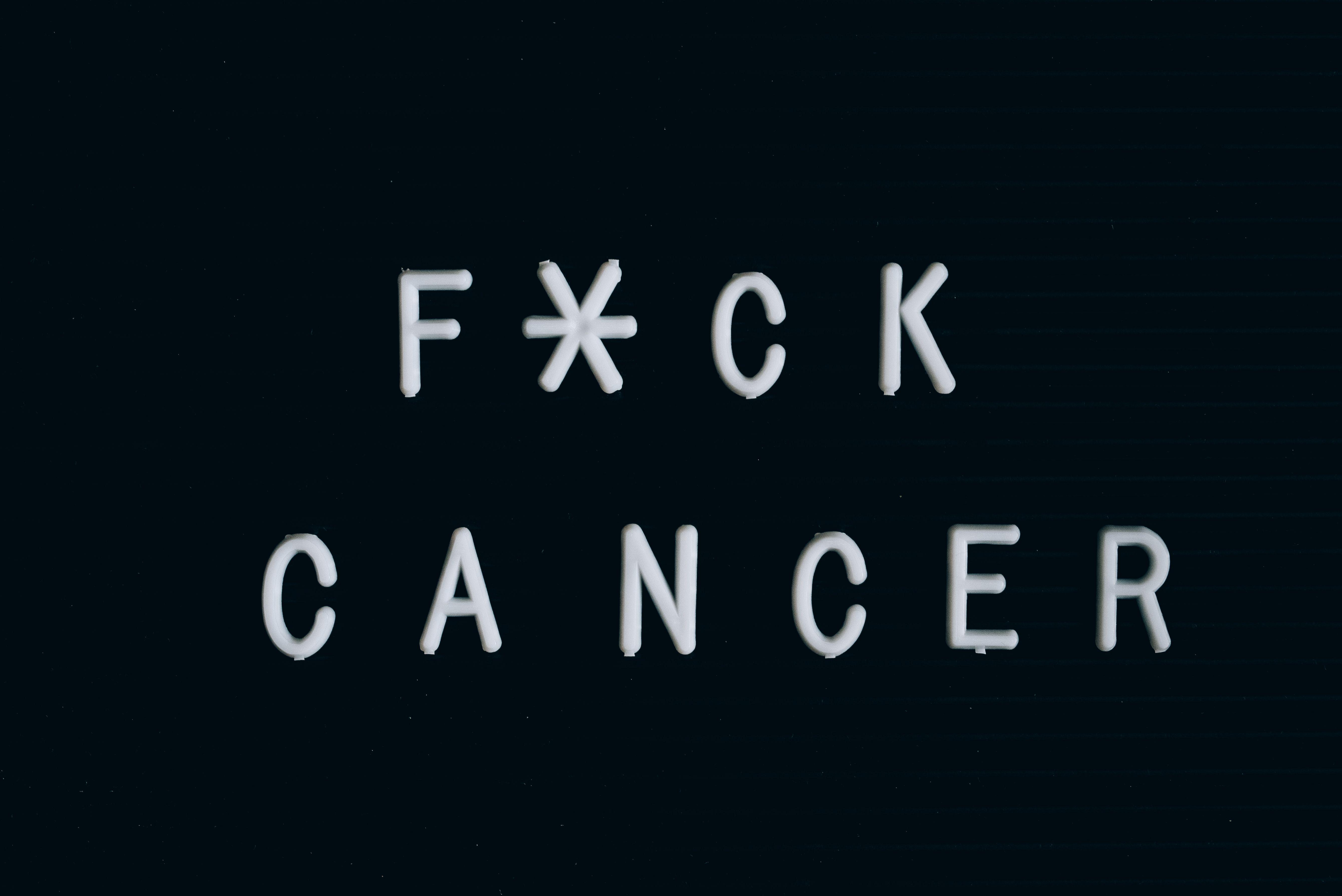 Motivational anti-cancer message on a letter board, emphasizing awareness.