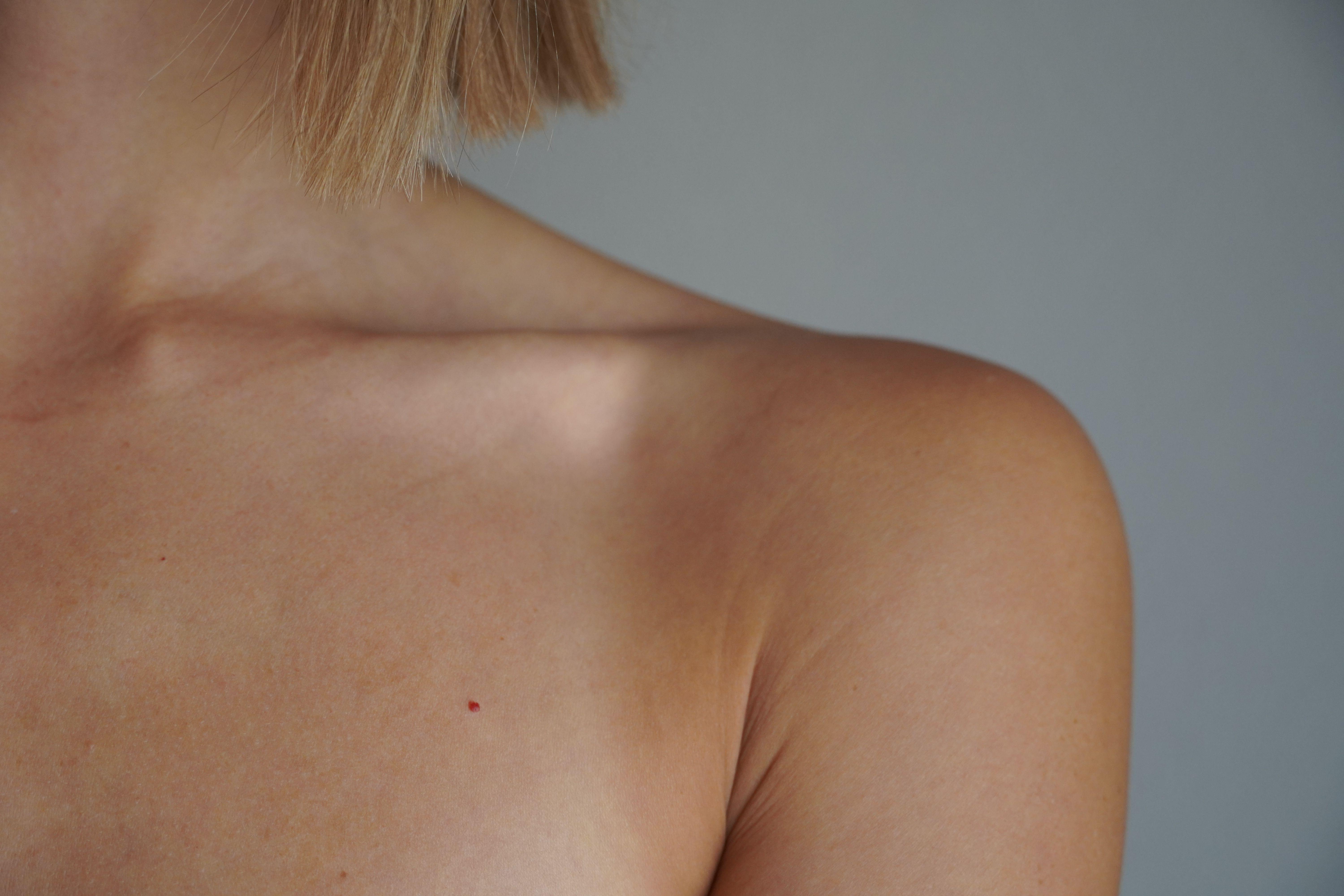 Detailed view of a woman's shoulder and skin tone with natural lighting.