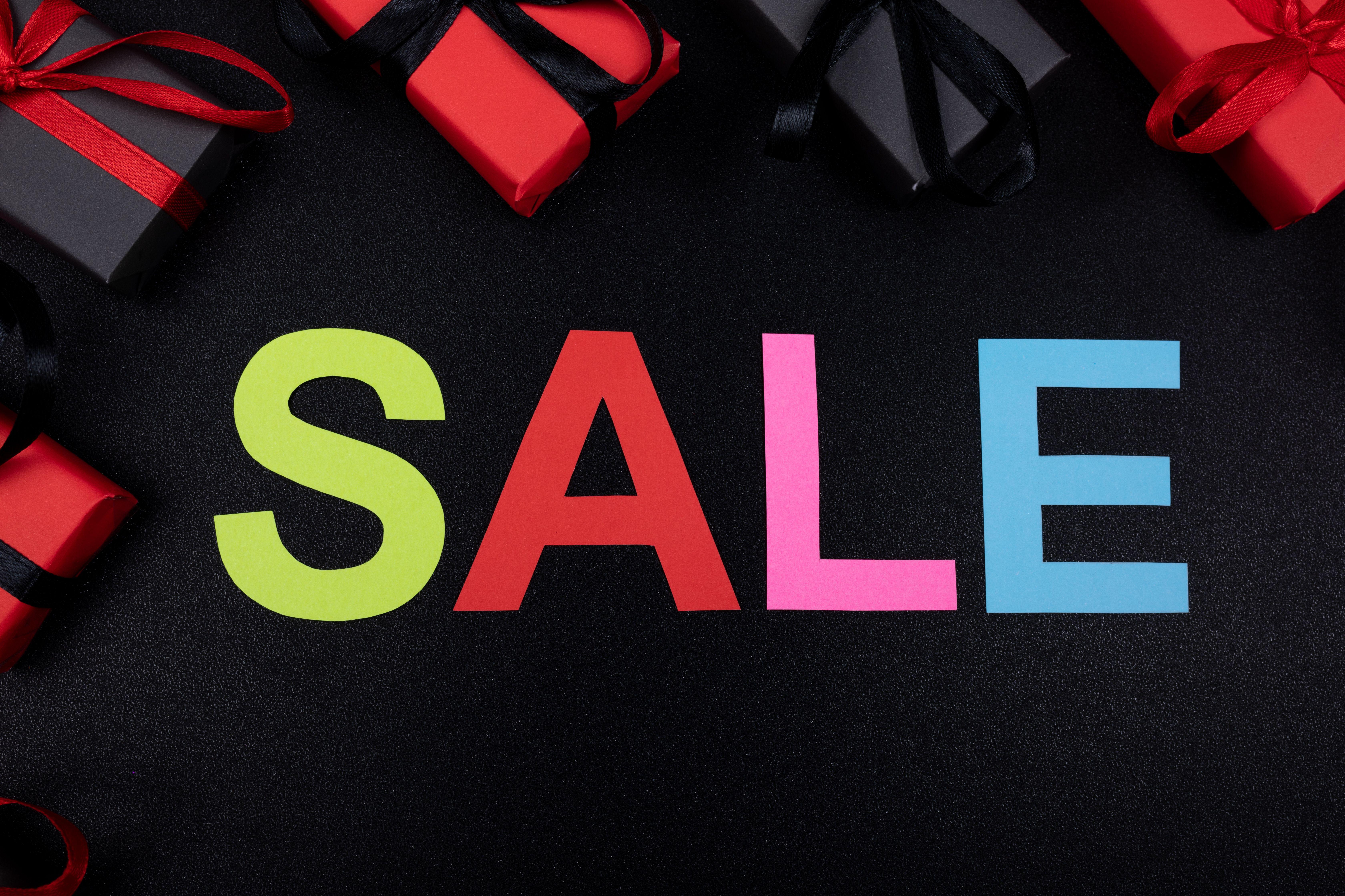 Vibrant SALE text surrounded by gift boxes offers perfect promotional imagery.
