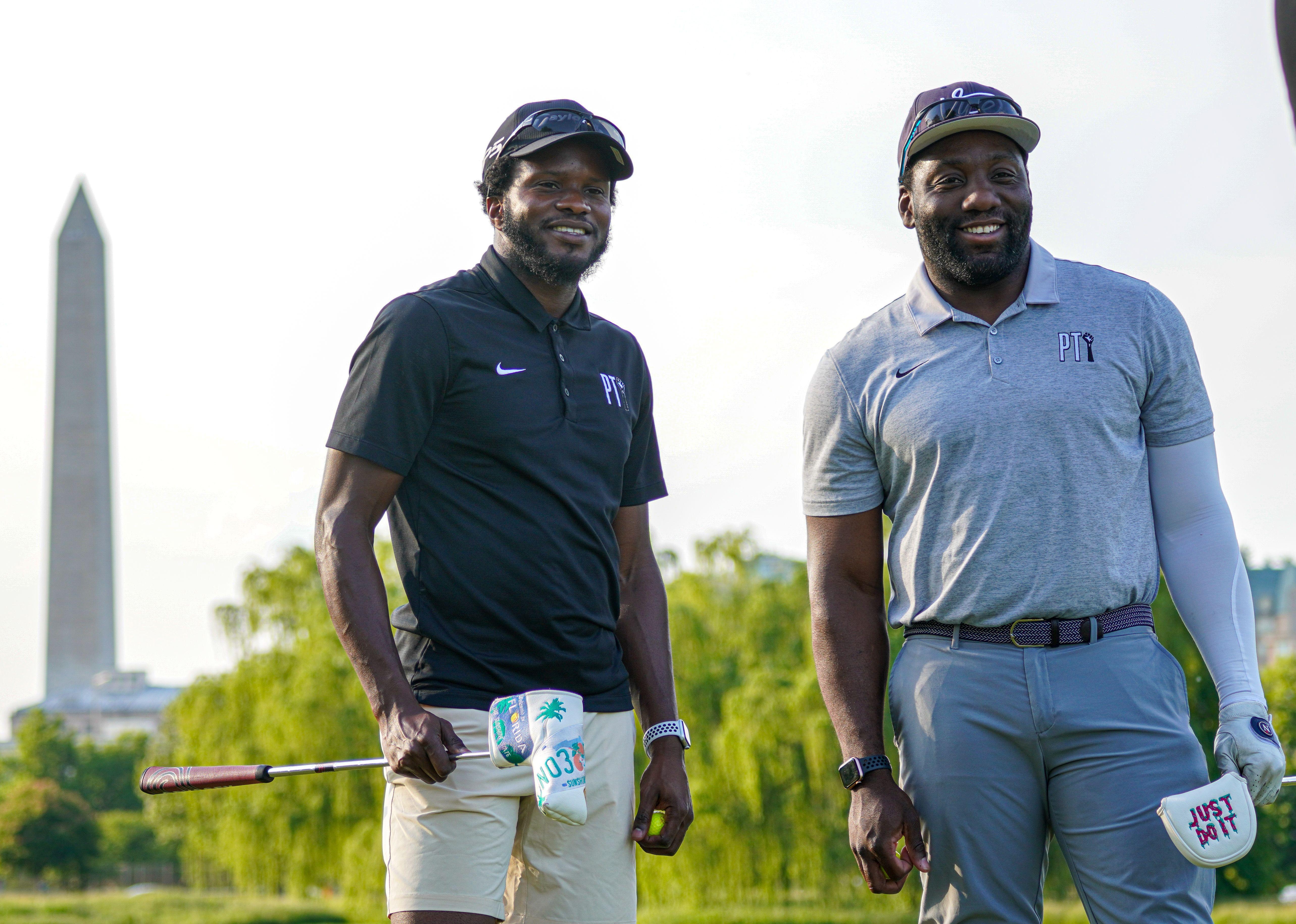 Two gentlemen enjoying a day of golf with the Washington Monument in the background.