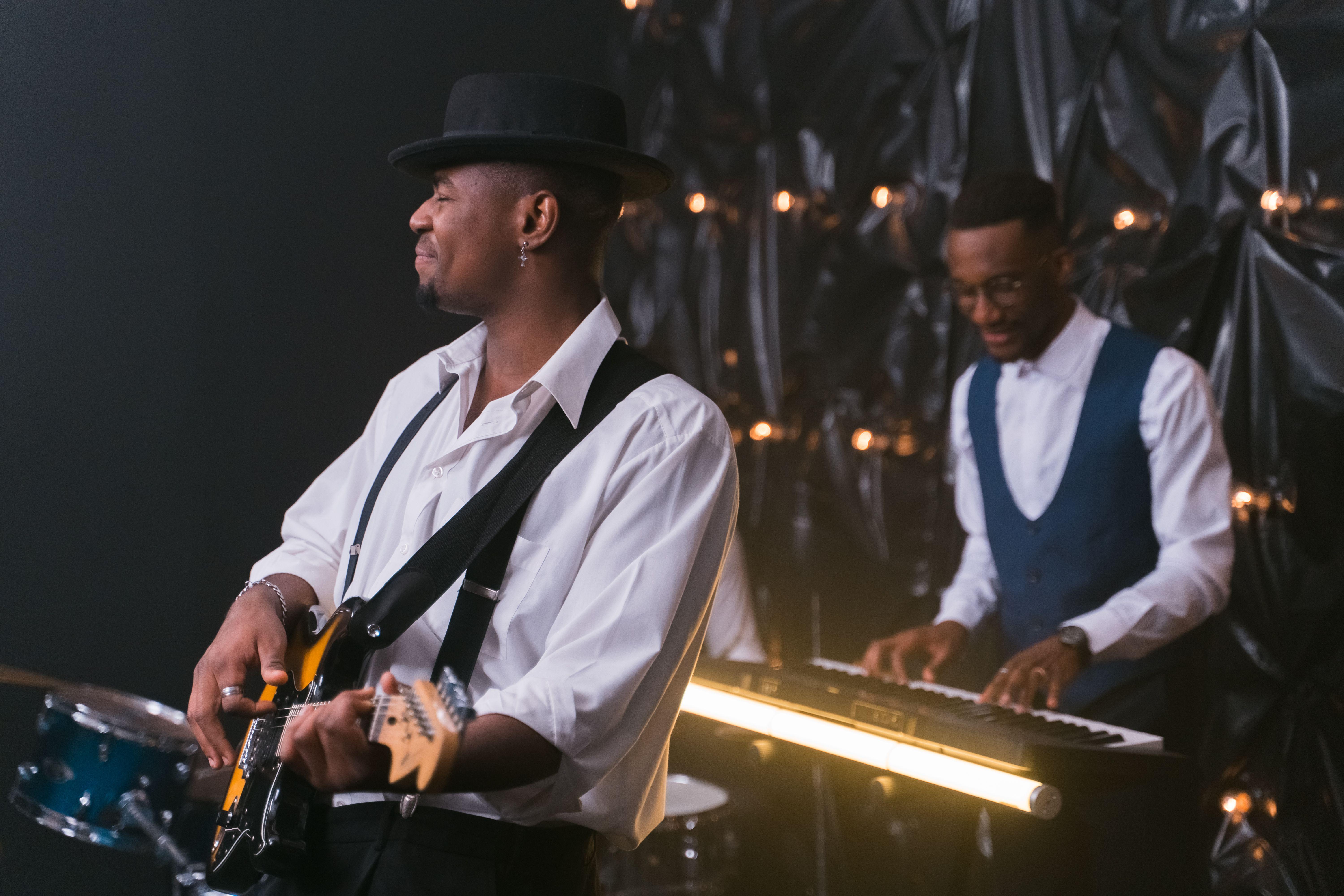 Energetic performance by jazz musicians with guitar and piano, creating soulful entertainment.
