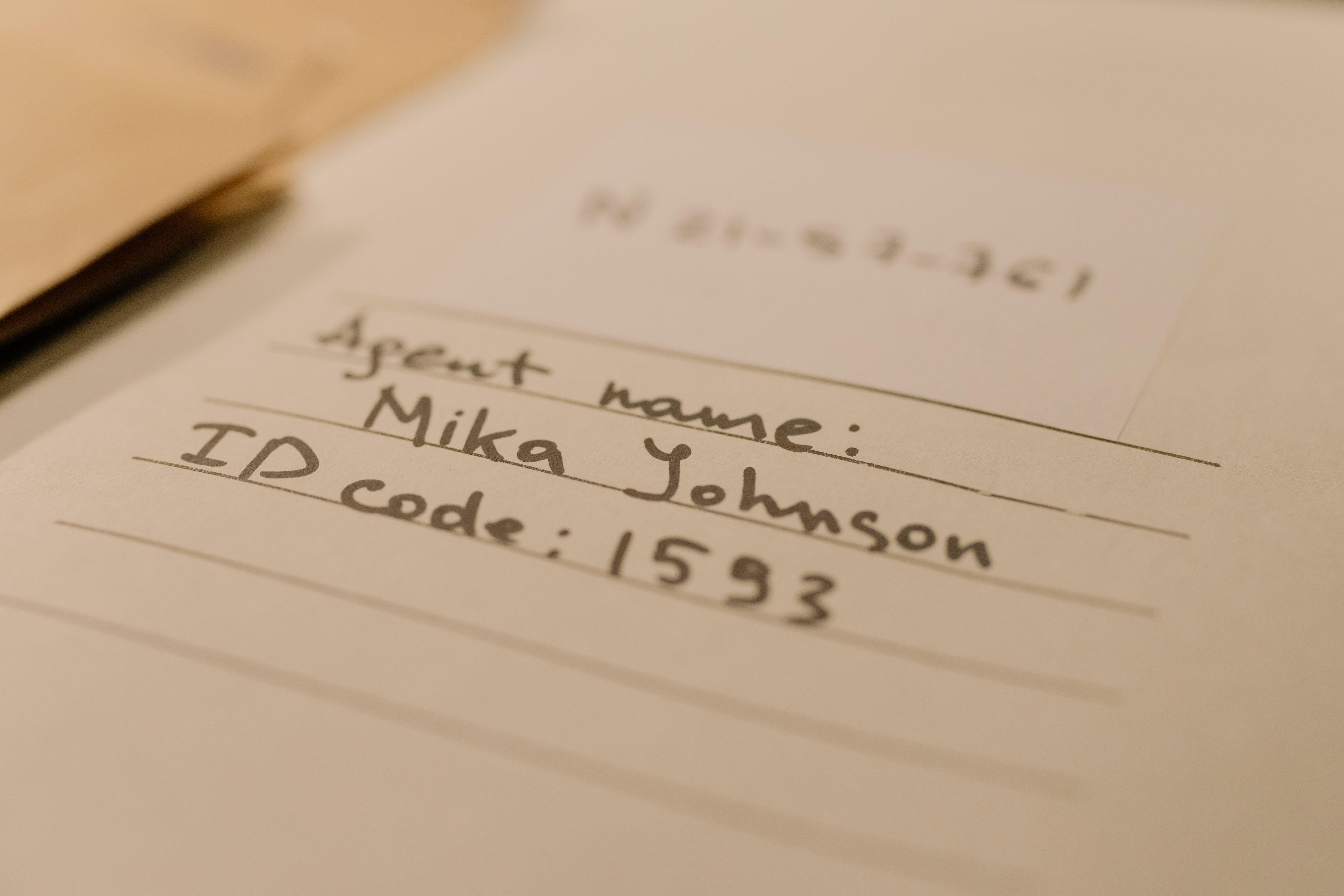 Handwritten document with agent name and ID code, showcasing personal handwritten text.