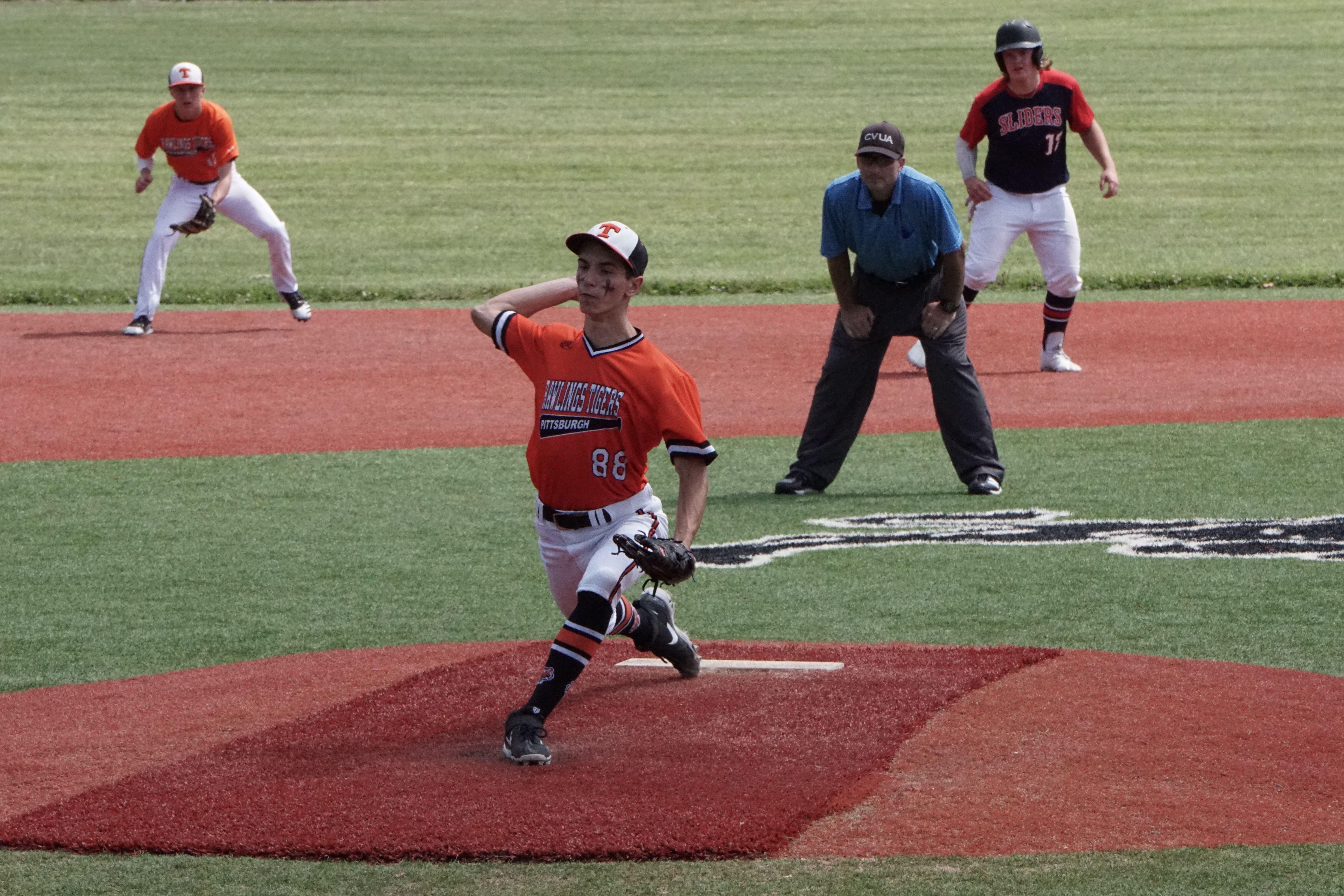 Pitcher in action during a high school baseball game on a sunny day.