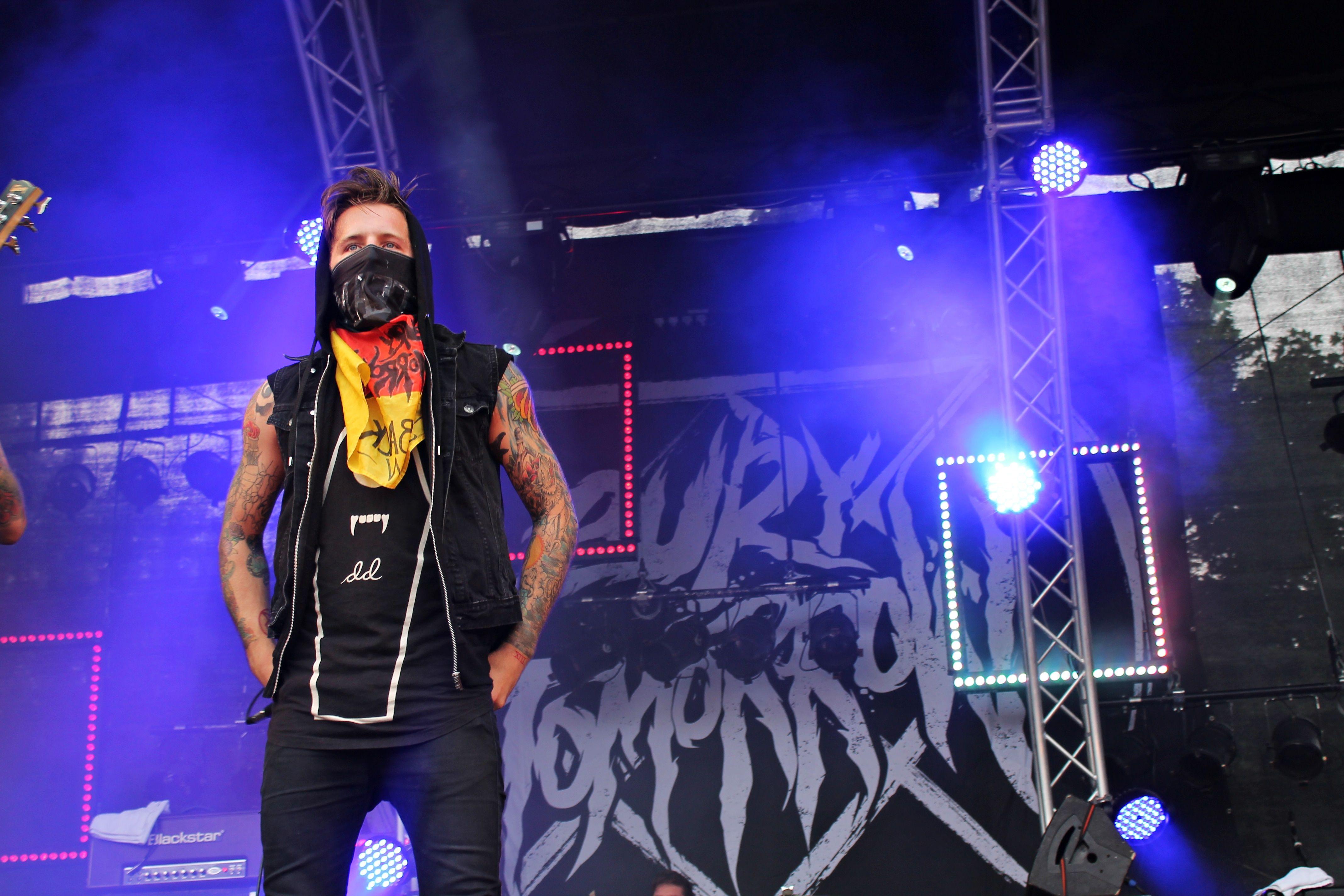 Vibrant stage performance by a metal band, featuring energetic lights and powerful presence.