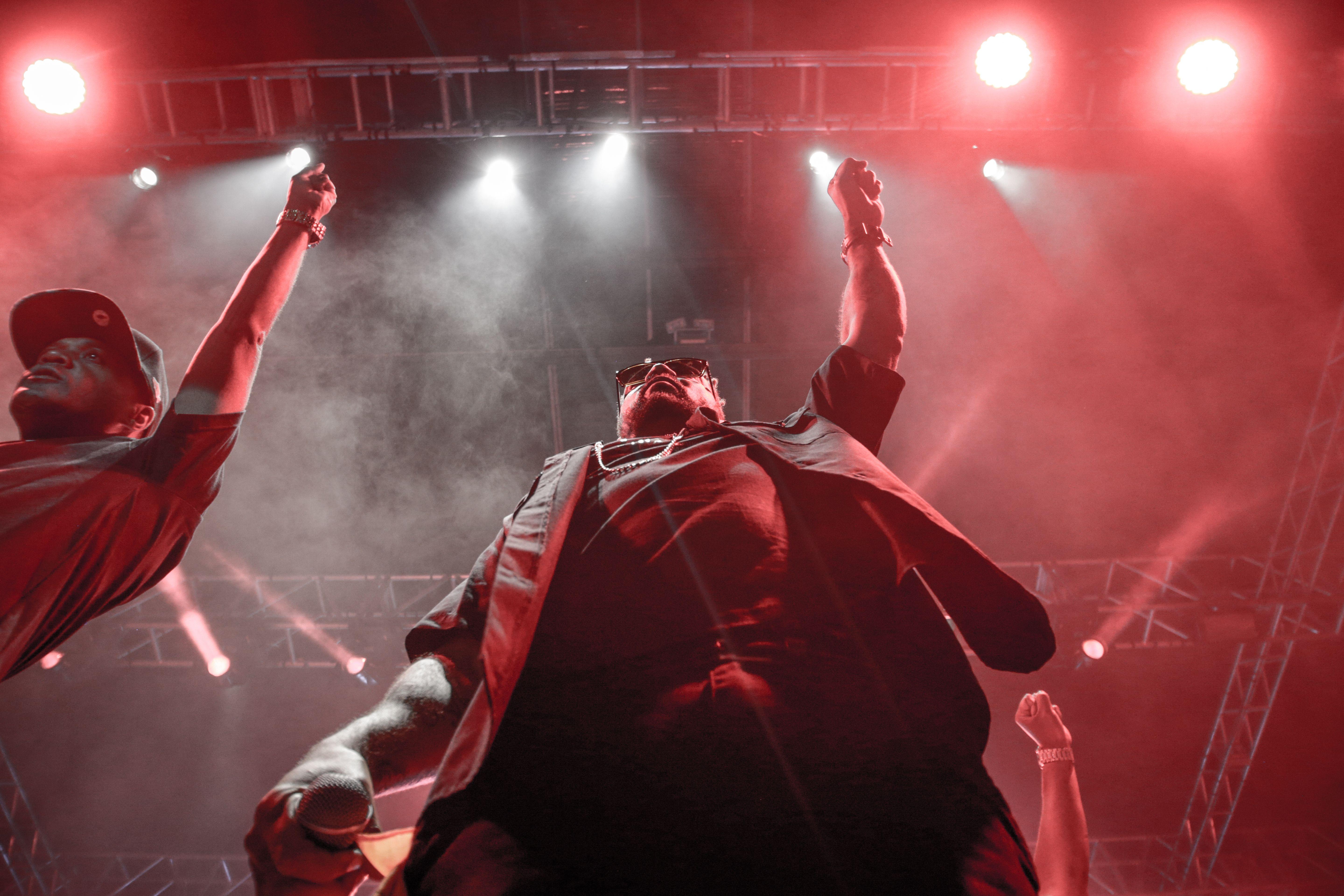 Dynamic stage performance with vibrant red lighting and audience engagement.
