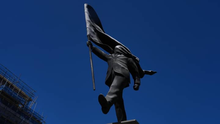 New Banksy statue of man blinded by flag draws crowds in London