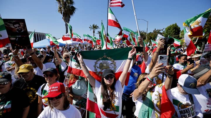 Iranian American protesters gather as football team prepare for World Cup opener
