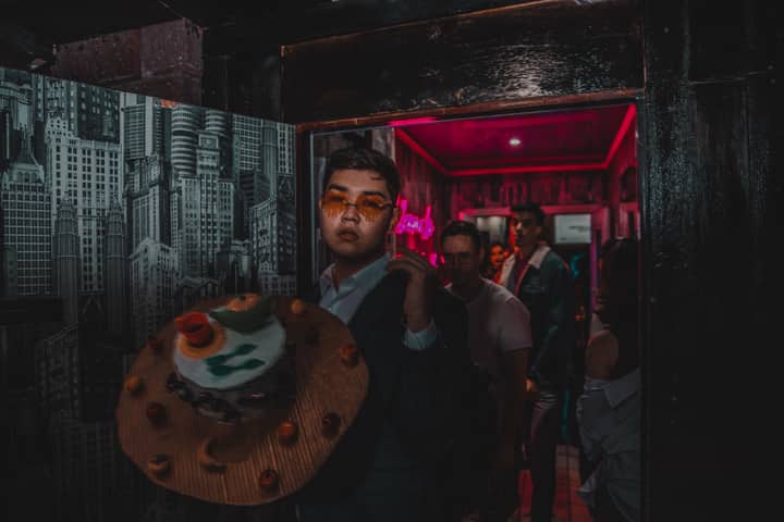 Stylish individuals enjoying a vibrant nightlife scene at a party.