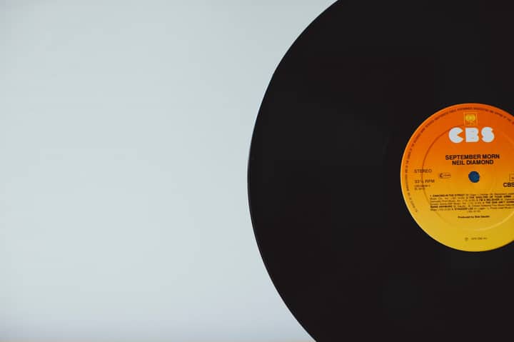A close-up of a vintage vinyl record with CBS label on a white background.
