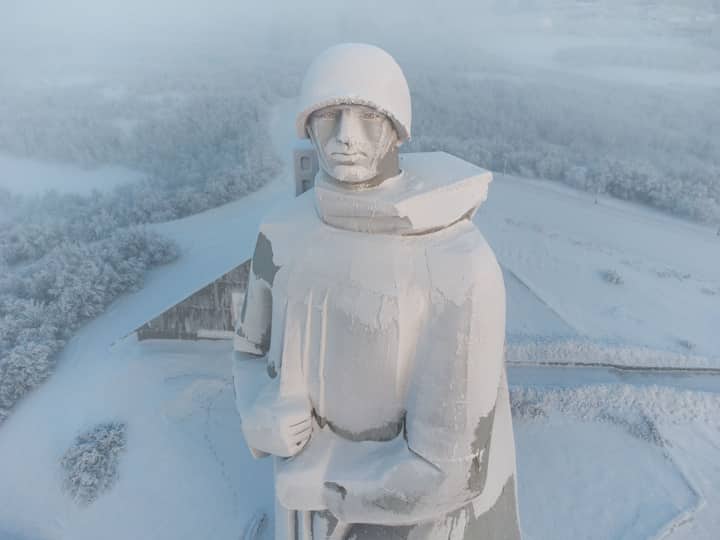 Aerial view of the snow-covered Alyosha monument in Murmansk during winter.