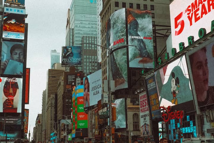 Colorful advertising billboards in Times Square, New York City, showcasing urban life.