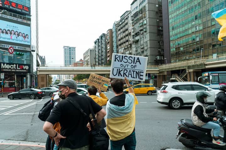 Protesters in the city holding signs against Russia's actions in Ukraine.