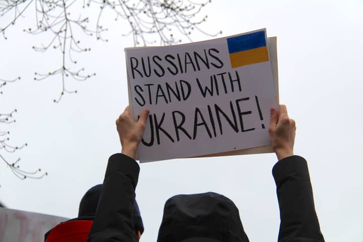Protesters in Vancouver hold signs supporting Ukraine against Russian actions.