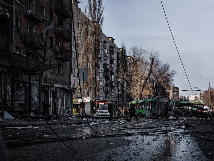 A war-damaged street in Kyiv, Ukraine, showing destruction and chaos.