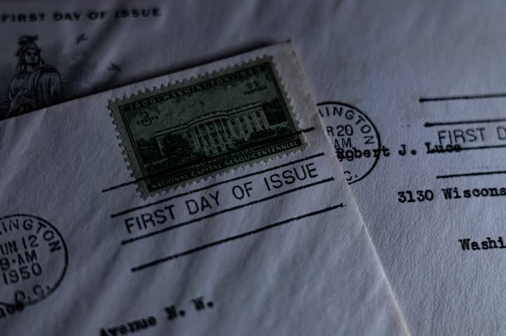 A close-up of a vintage first day of issue postage stamp on an envelope, evoking nostalgia.