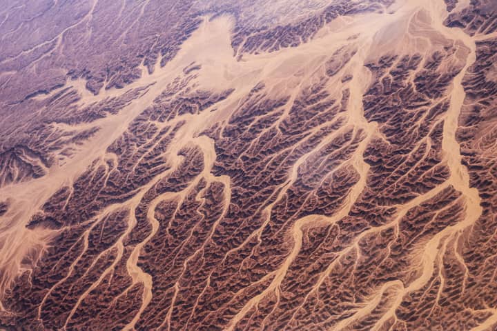 A breathtaking aerial view showcasing the intricate desert dunes and textures of Egypt's arid landscape.