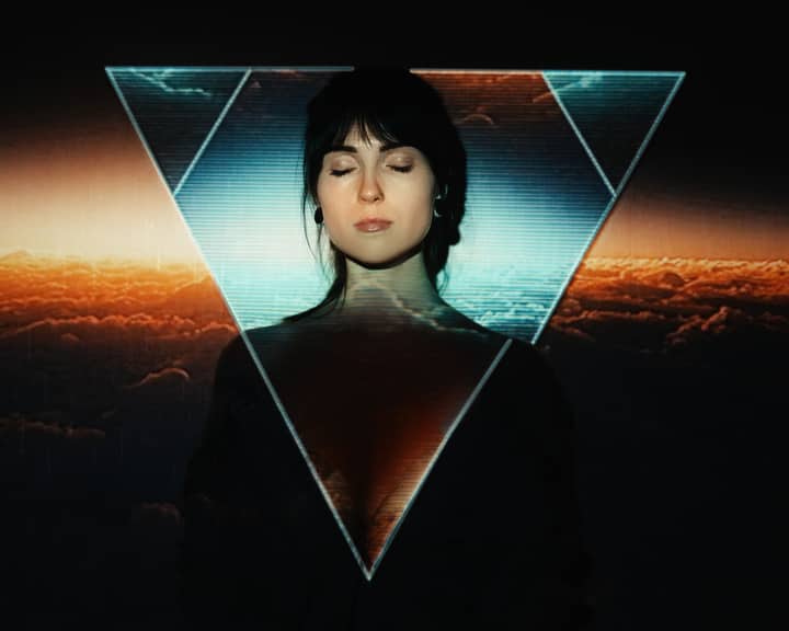 Creative portrait of a woman with closed eyes and triangle overlay during golden hour.