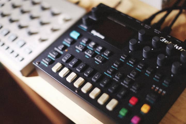 A detailed view of an Elektron synthesizer showcasing buttons and knobs for music production.