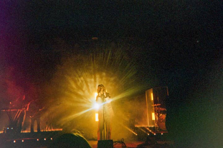 A dynamic live performance with stunning backlit lighting highlights the energetic ambiance.