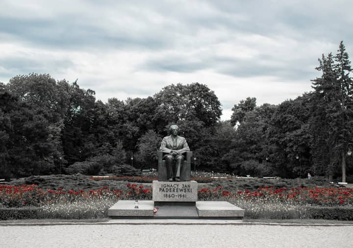 Monument of Ignacy Jan Paderewski surrounded by trees in Warsaw park, Poland.