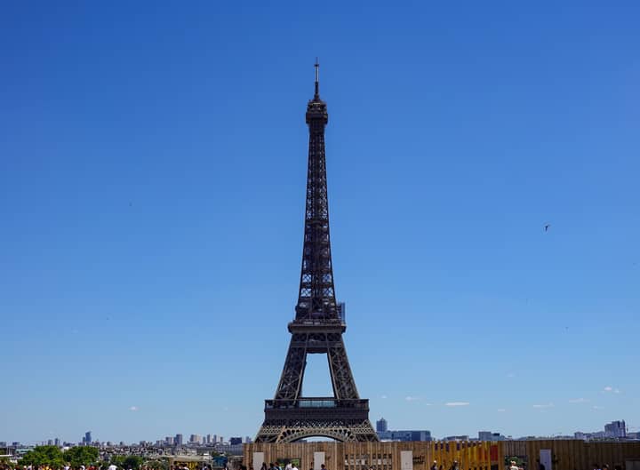 Iconic Eiffel Tower in Paris with clear blue sky, a symbol of France's architectural grandeur.